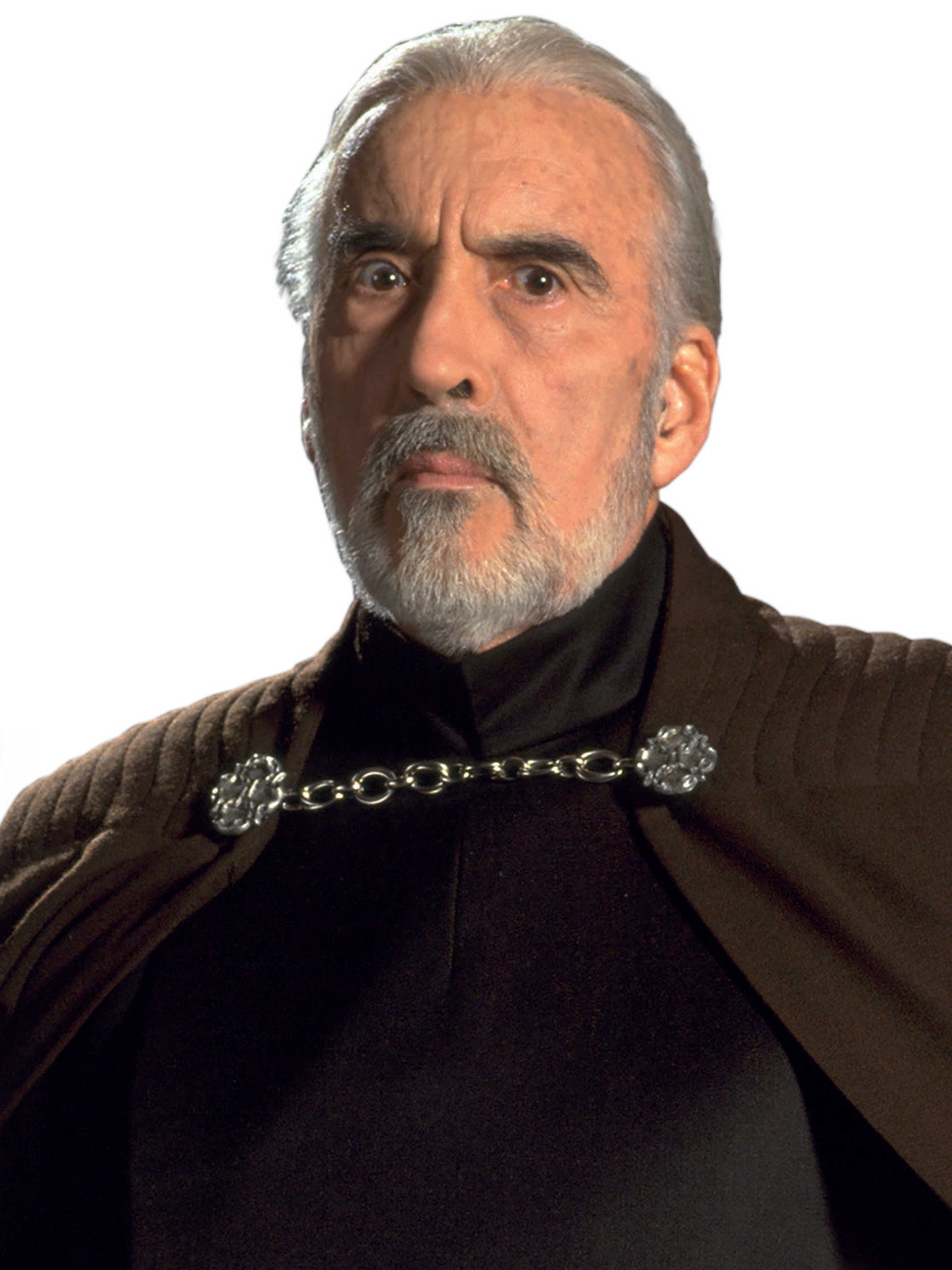 An elderly man with long gray hair and a beard, wearing a dark robe with an ornate clasp.