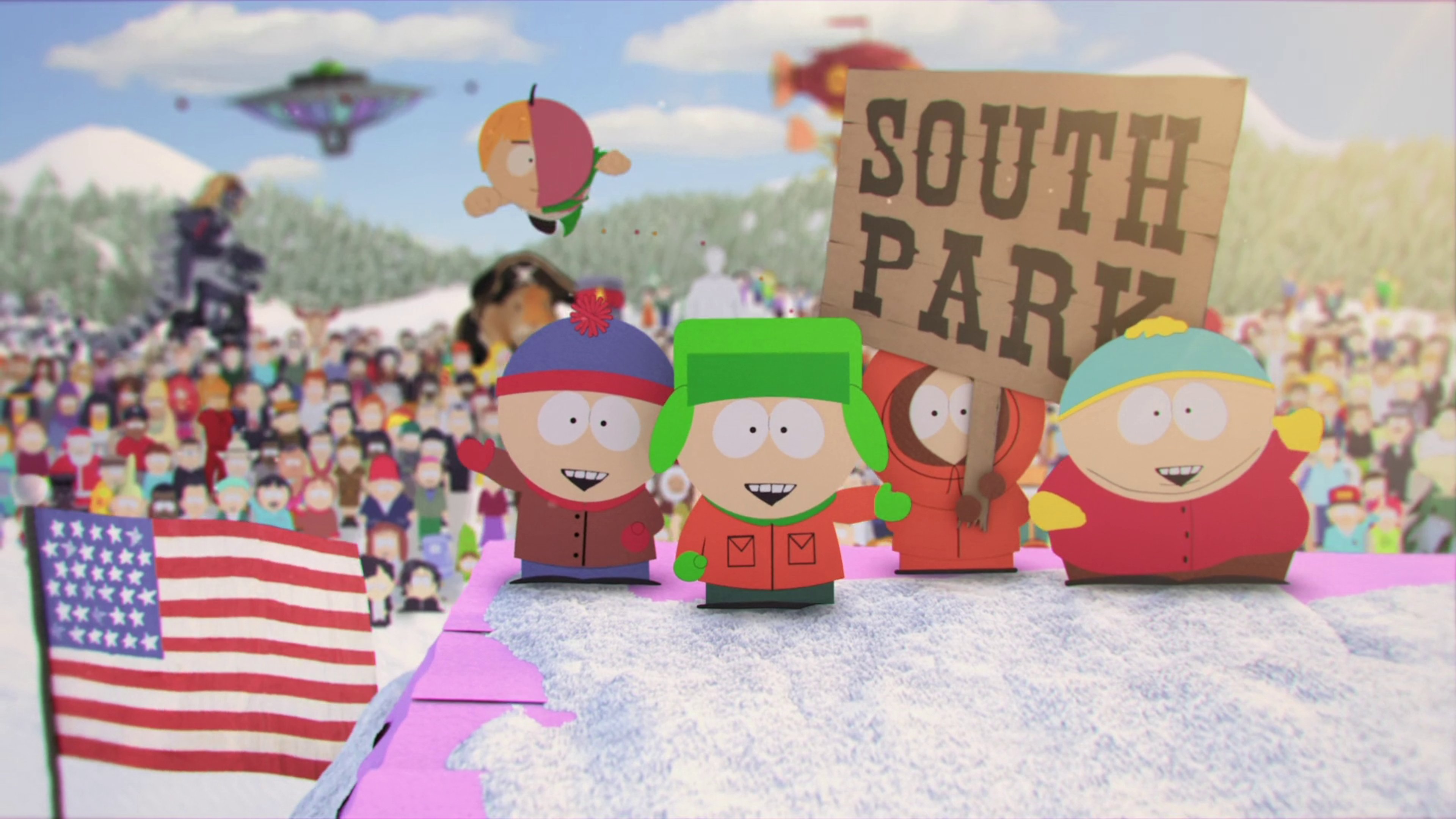 Four cartoon characters from the TV show South Park standing in a festive, carnival-like setting