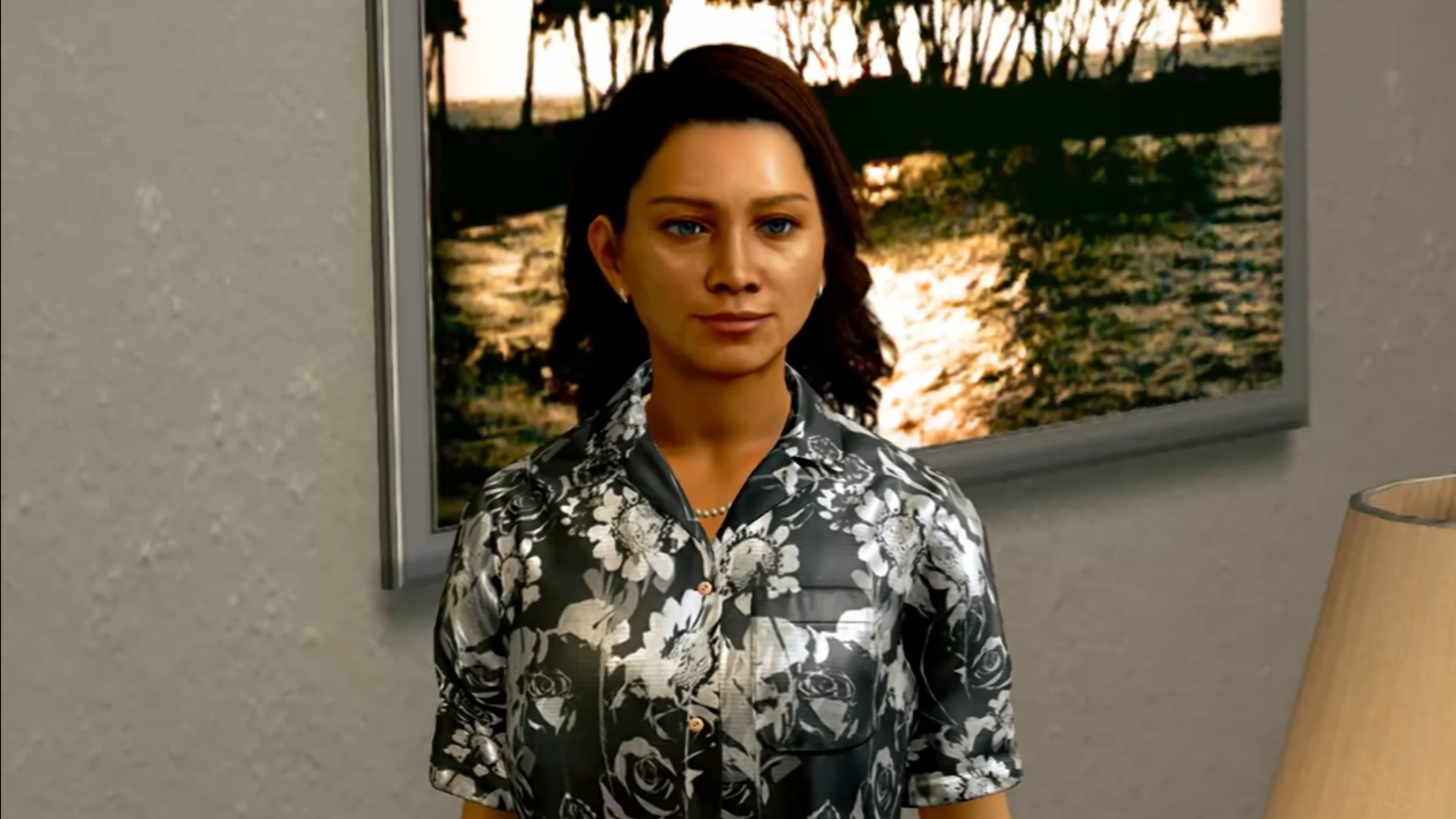 A woman with dark hair wearing a floral print blouse