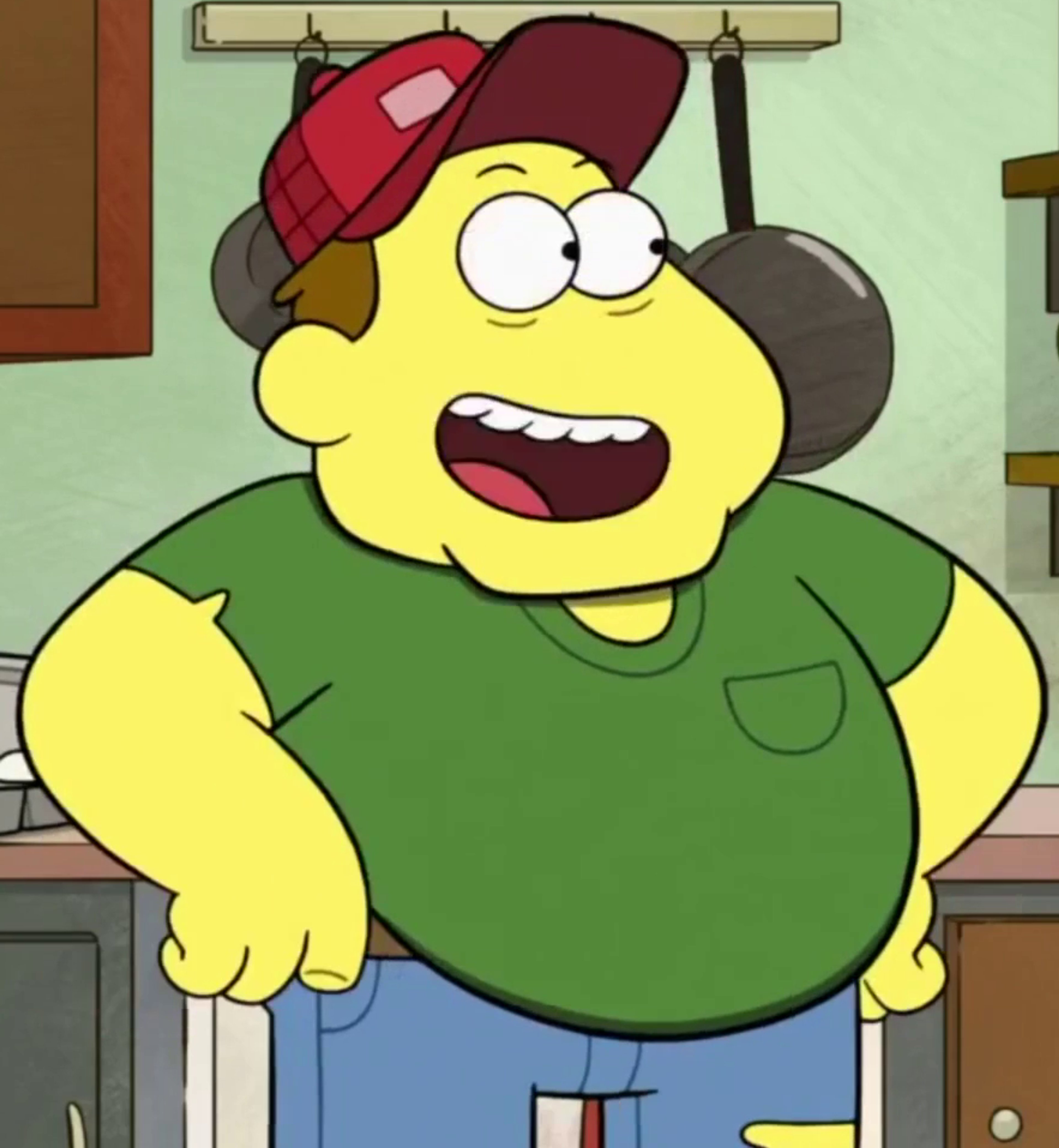 A cartoon character with a large, round yellow body, wearing a green shirt and red baseball cap, with a wide, toothy grin.