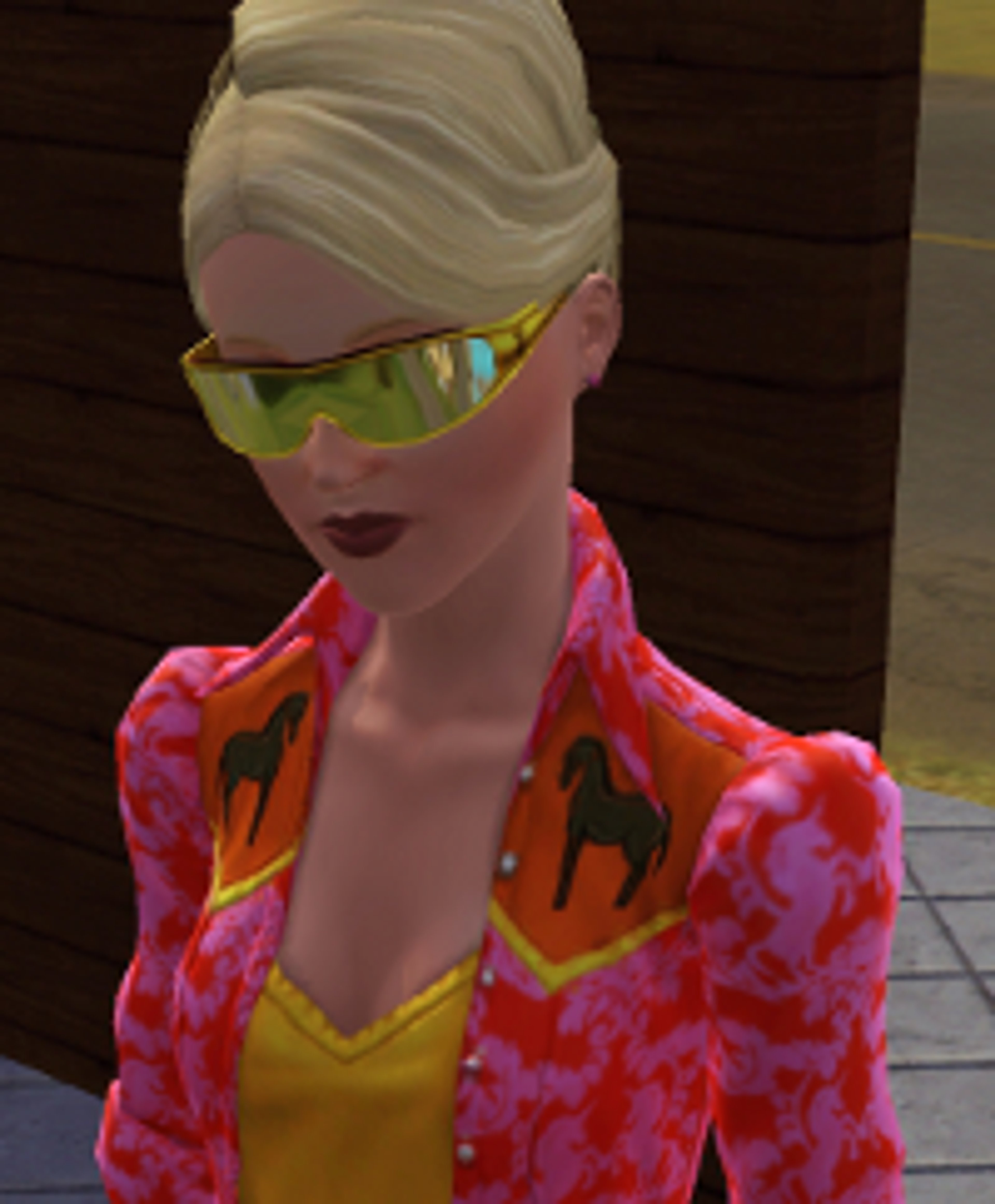 A woman with blonde hair and sunglasses wearing a colorful patterned jacket.
