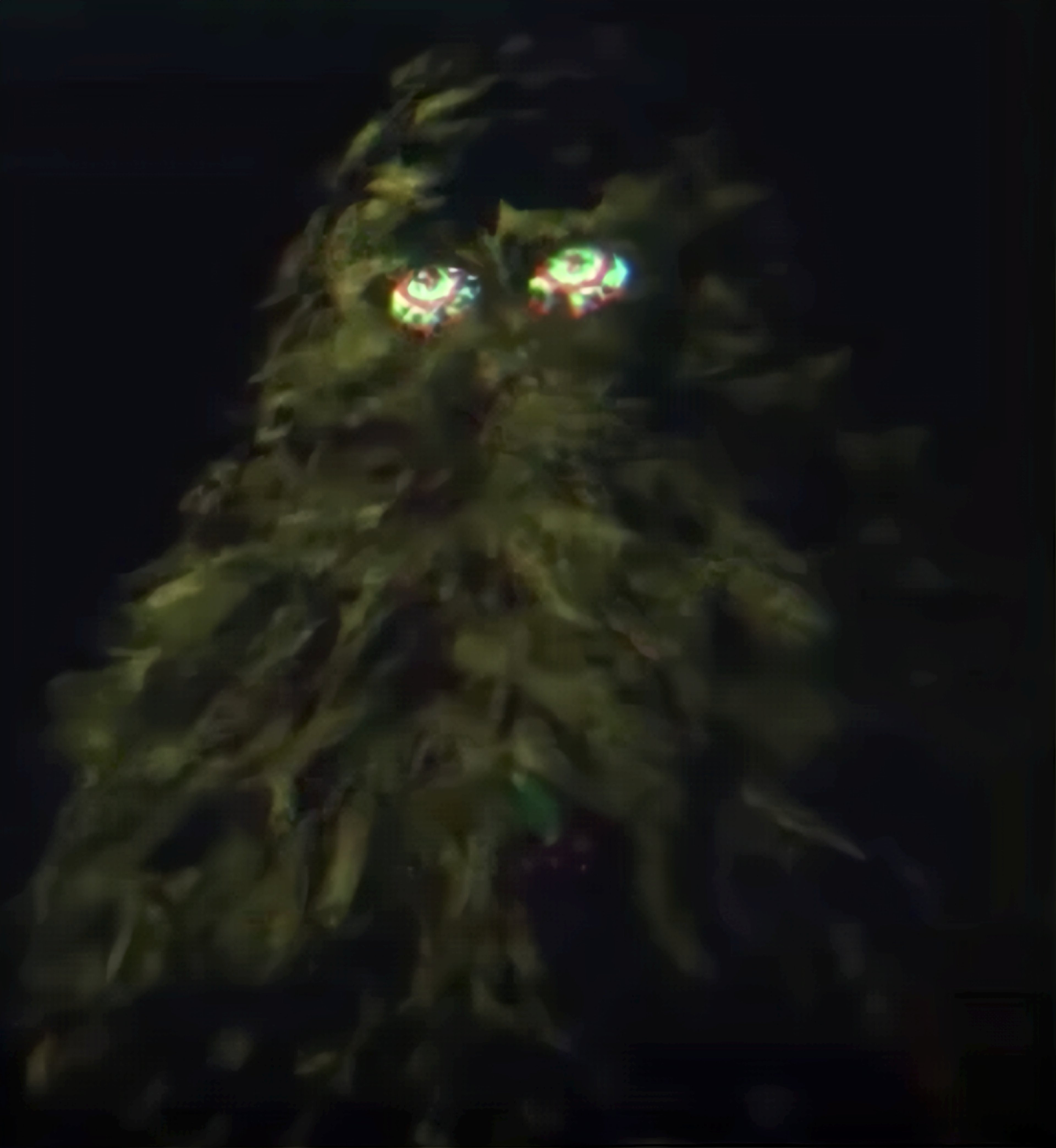 A close-up of a dark, leafy plant or tree with a mystical, eerie appearance.