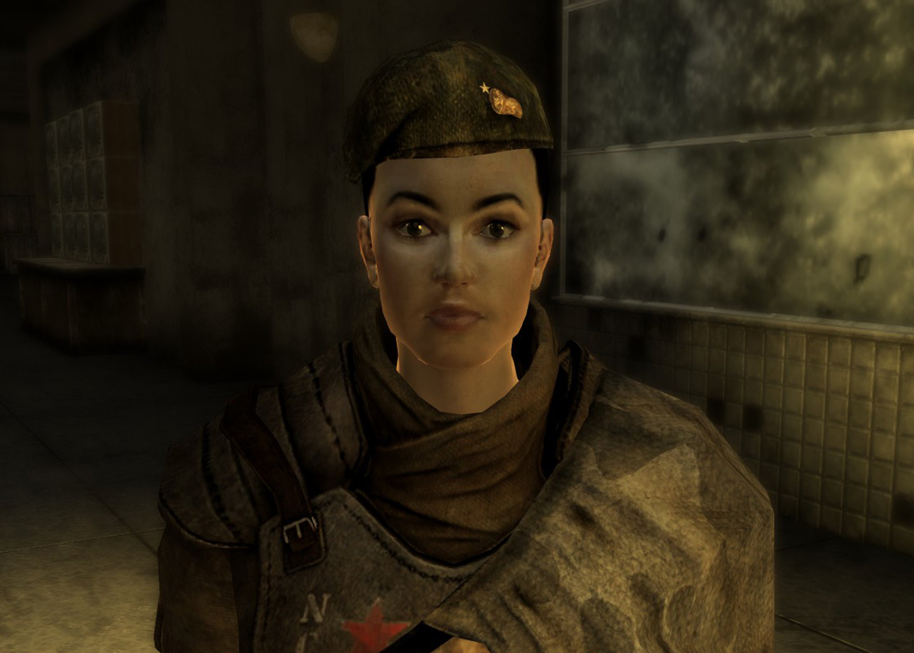 A woman in military uniform with a serious expression, standing in a military setting