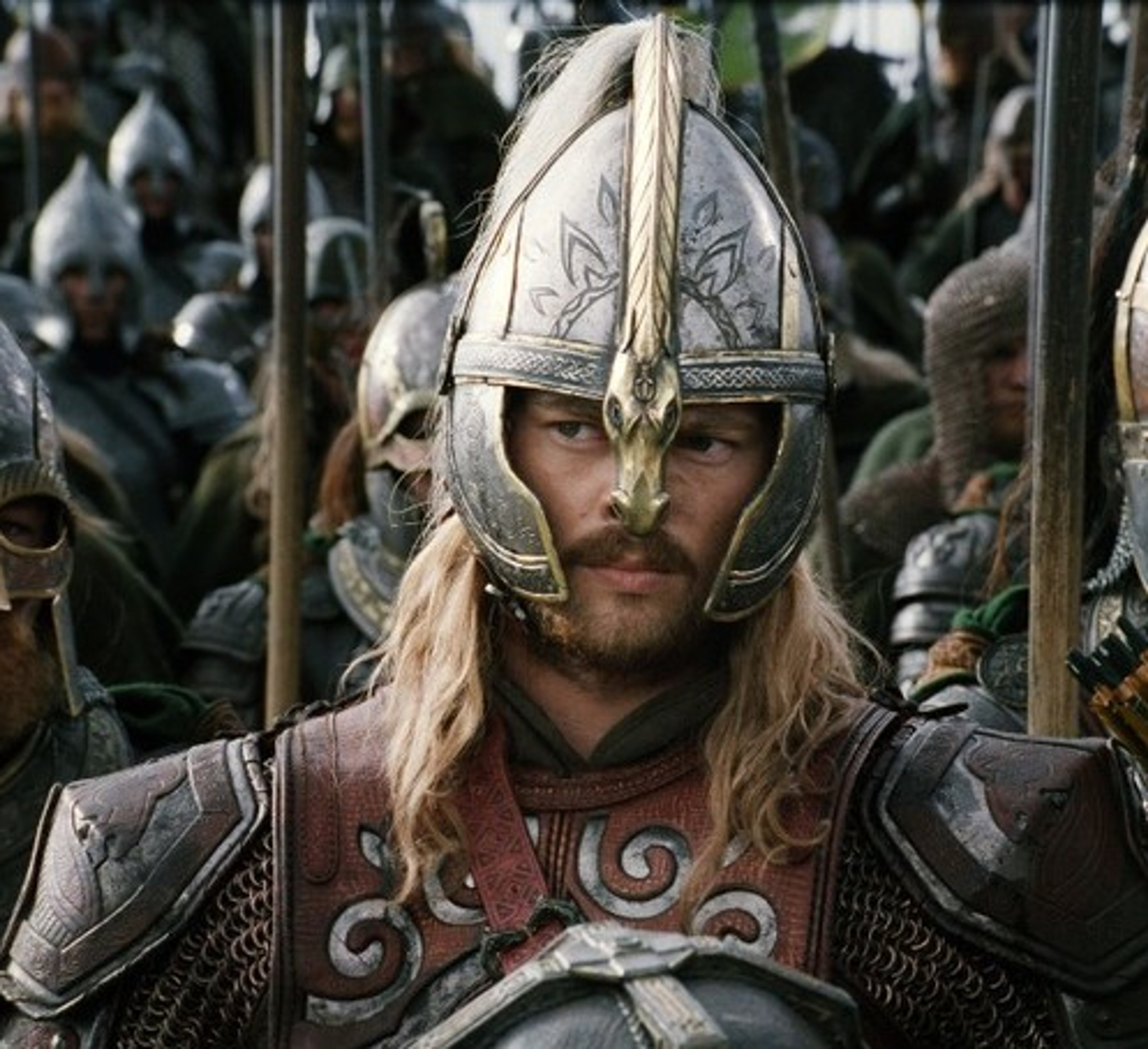 A warrior in ornate armor with a sword, standing with a commanding presence.