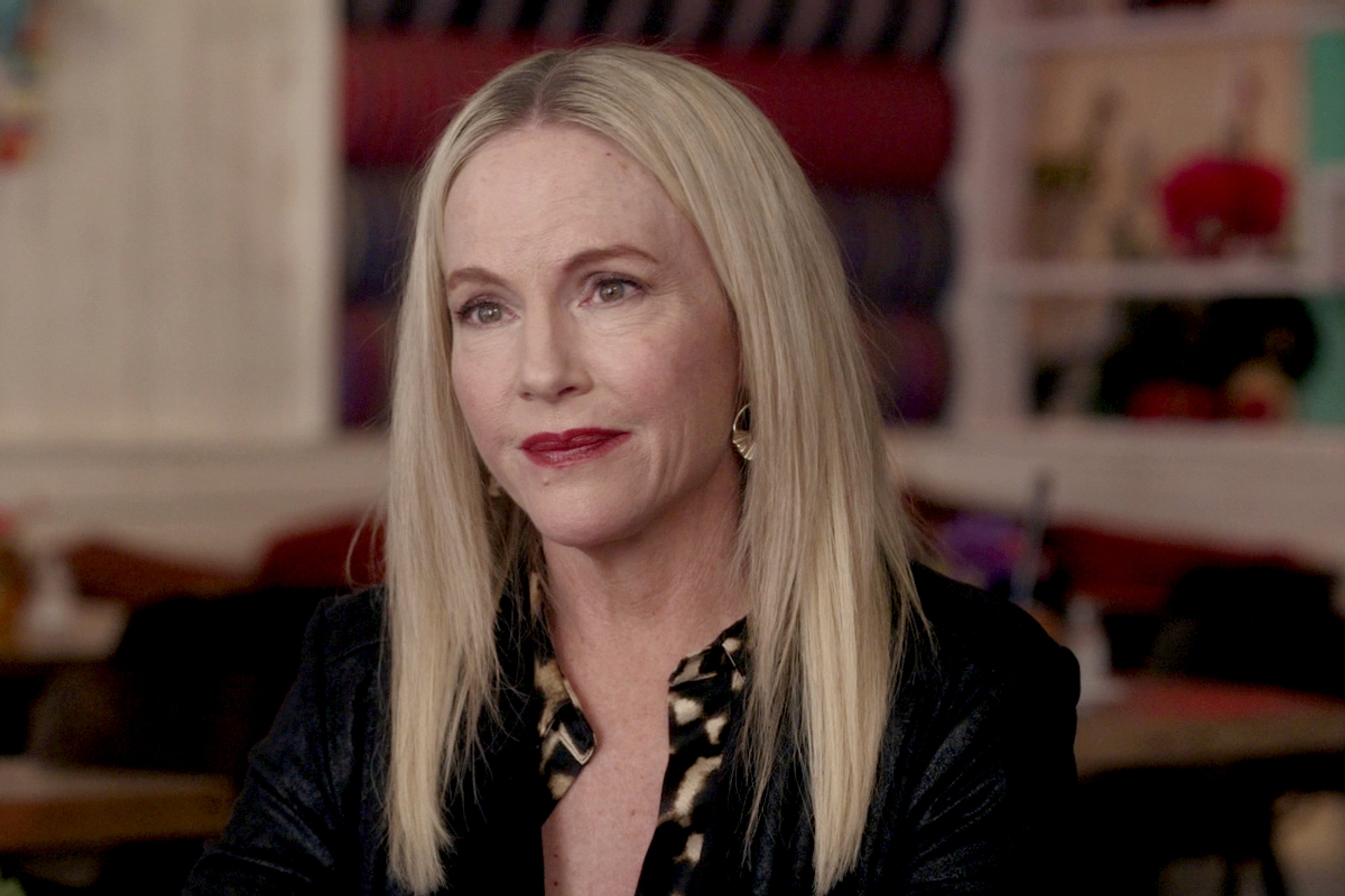 A middle-aged professional woman with blonde hair in a black jacket