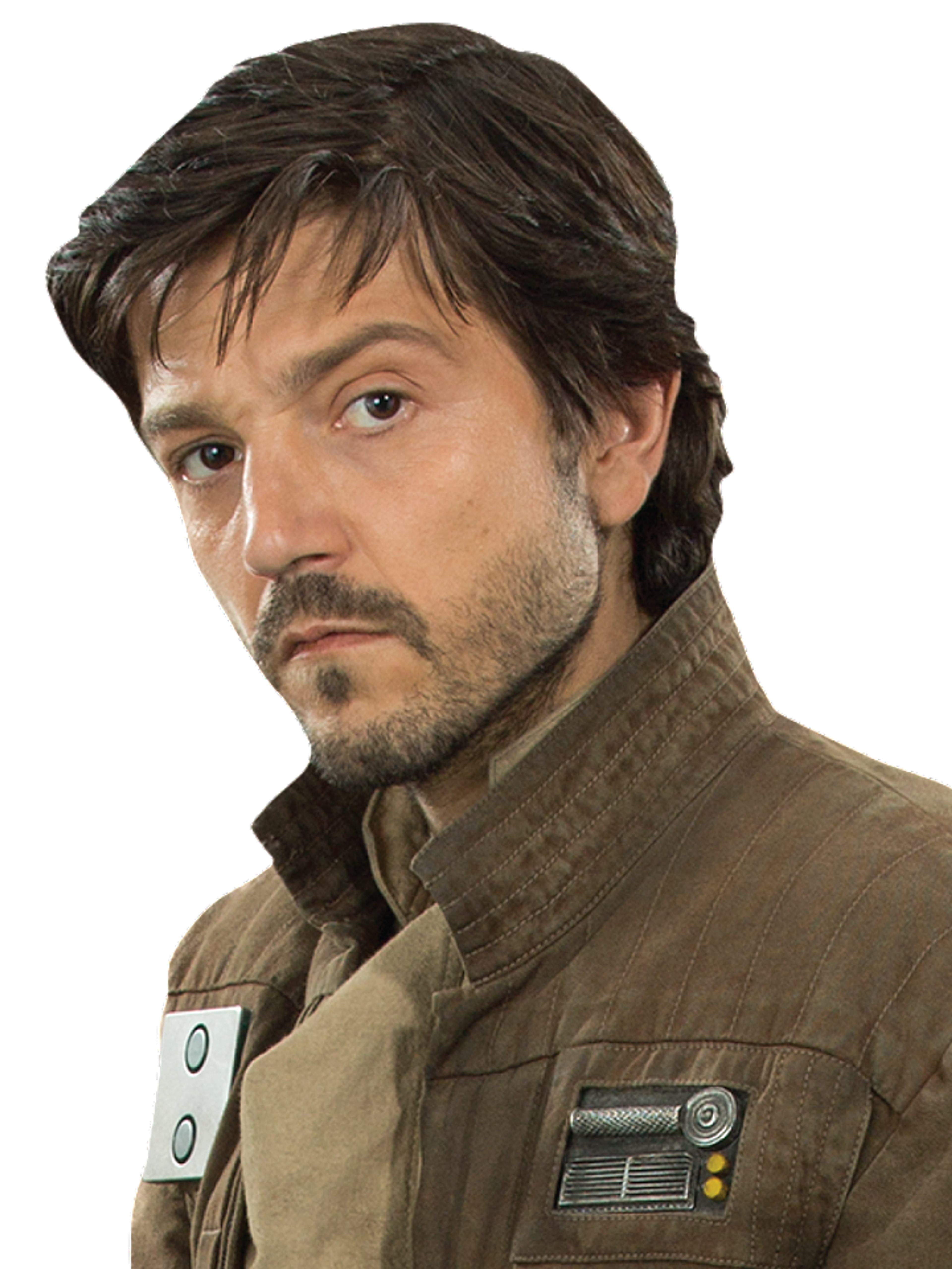 A man with dark hair and a beard wearing a tan military jacket