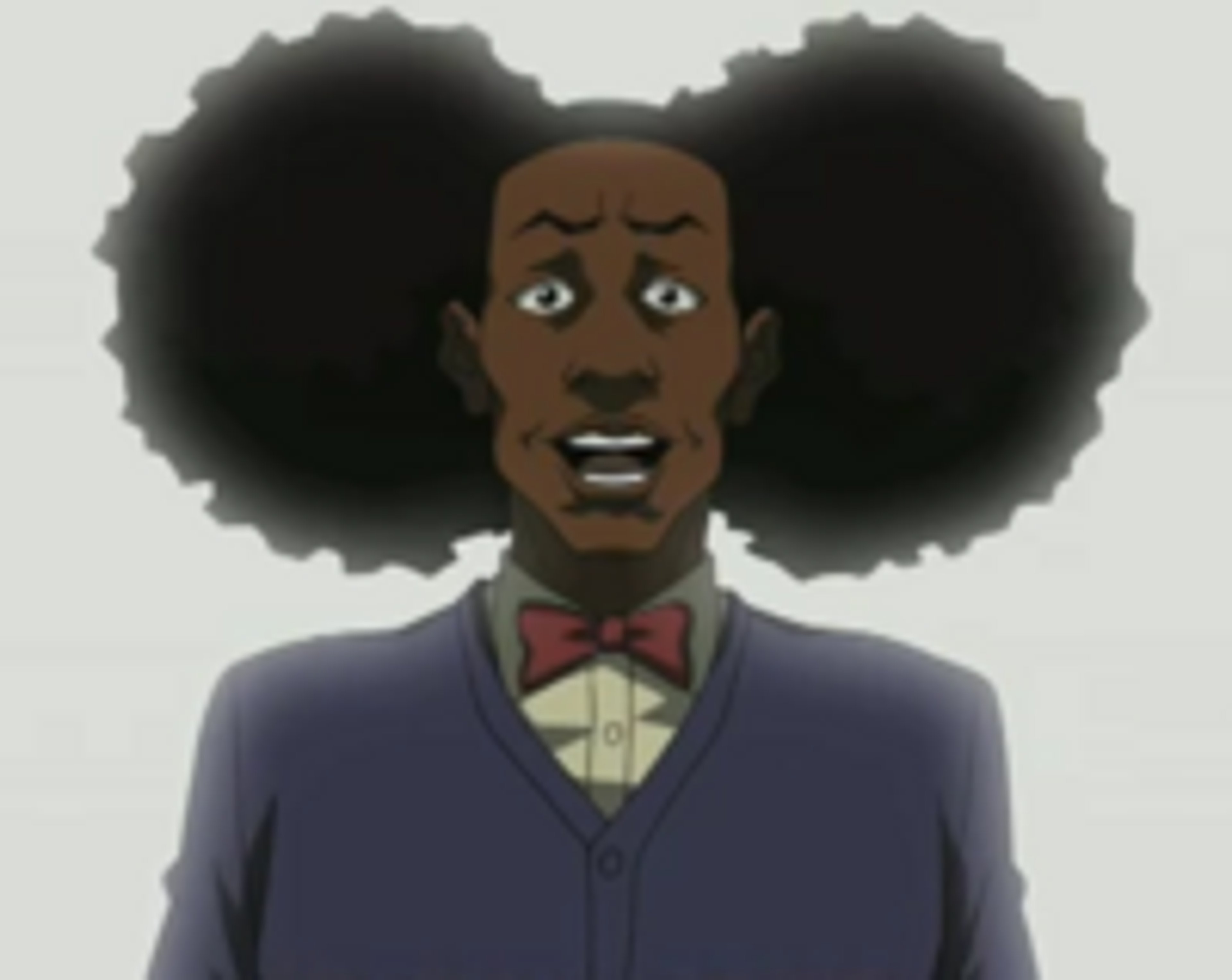 A Black man with a large afro wearing a purple suit jacket and red bow tie