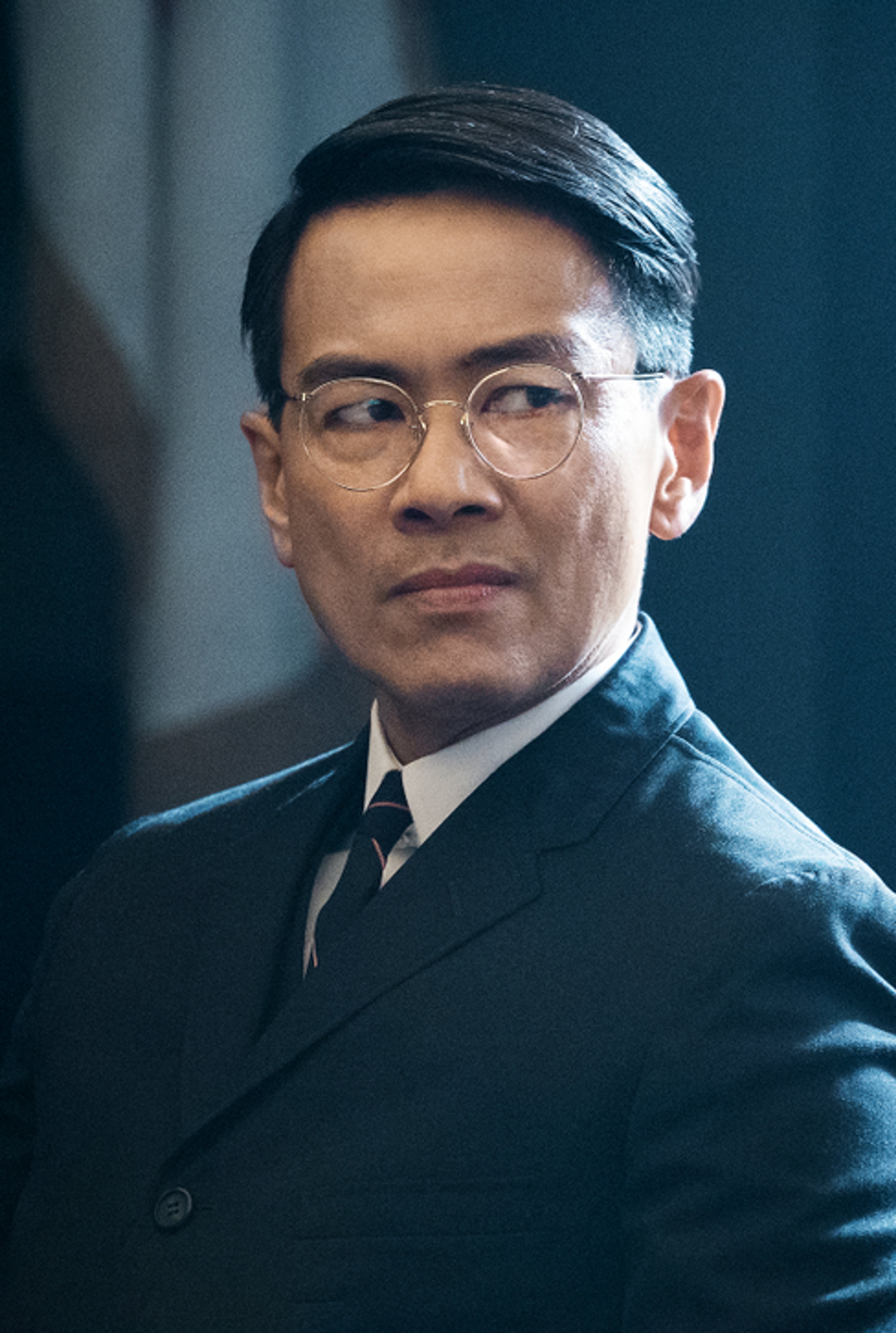 Portrait of a serious-looking Asian man in a suit
