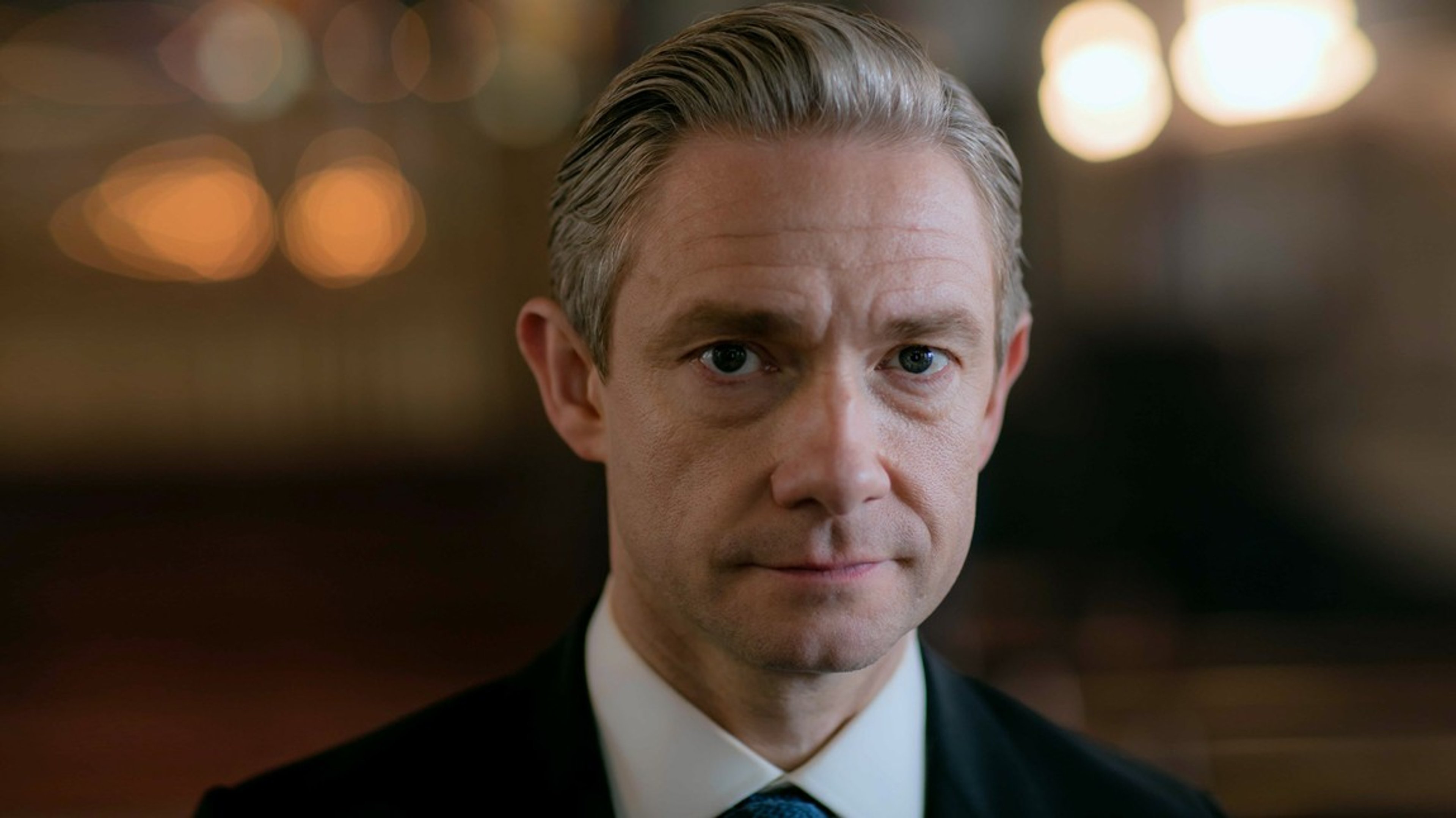 A man in a suit with a serious expression