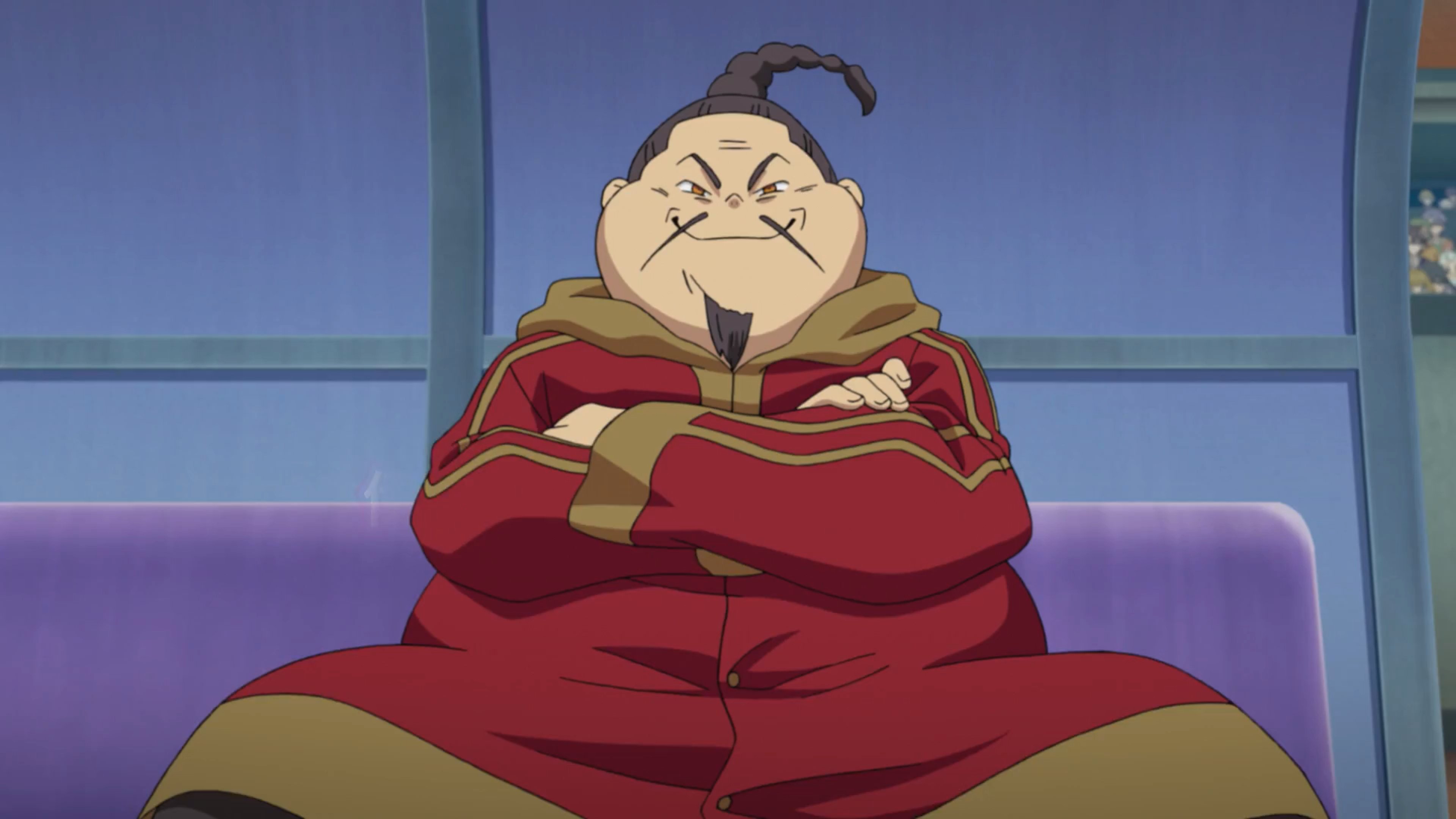 A short, stout Chinese man with a black mustache and goatee, wearing a red jacket with gold trim.