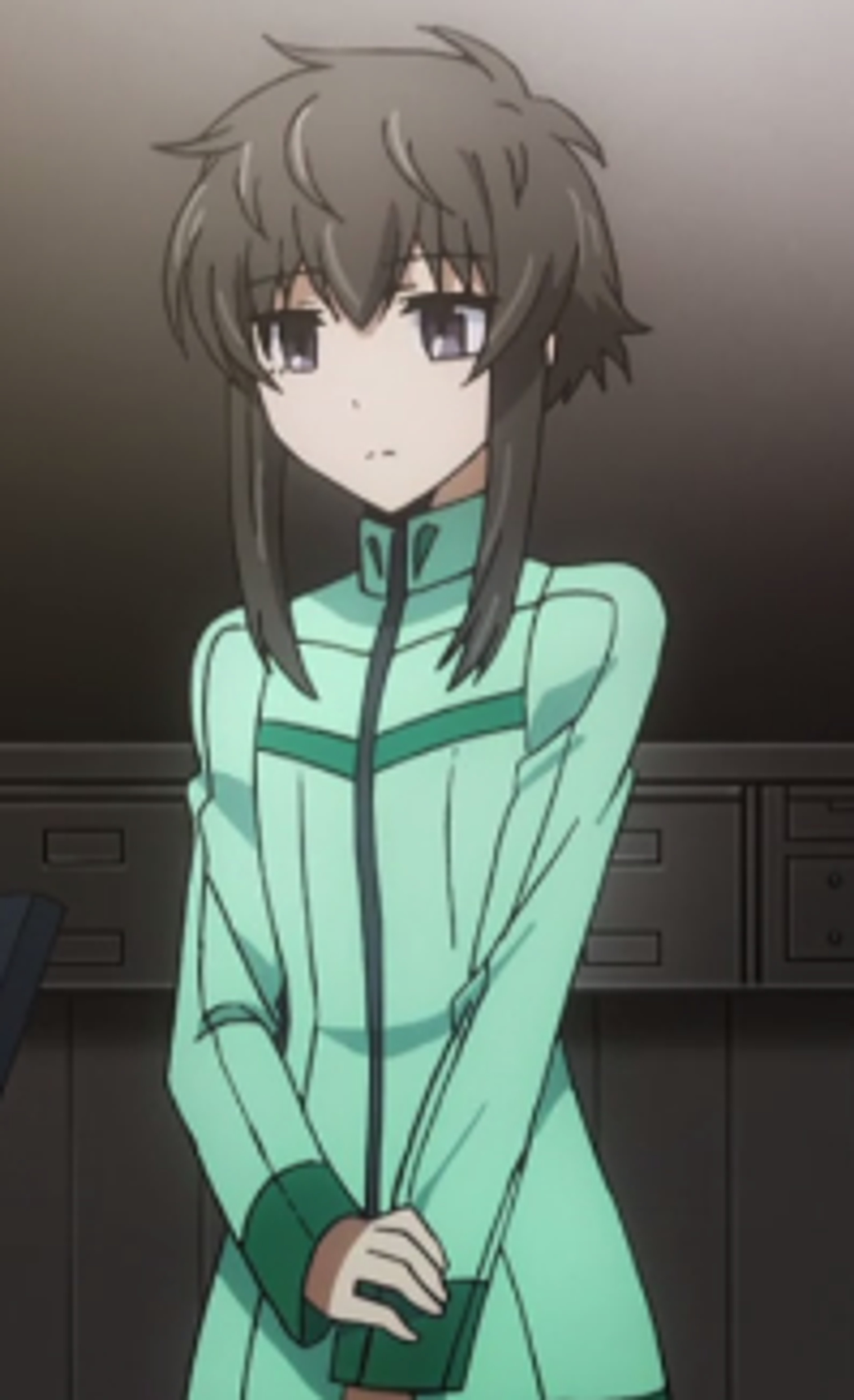 A young woman with dark hair wearing a green jacket or uniform