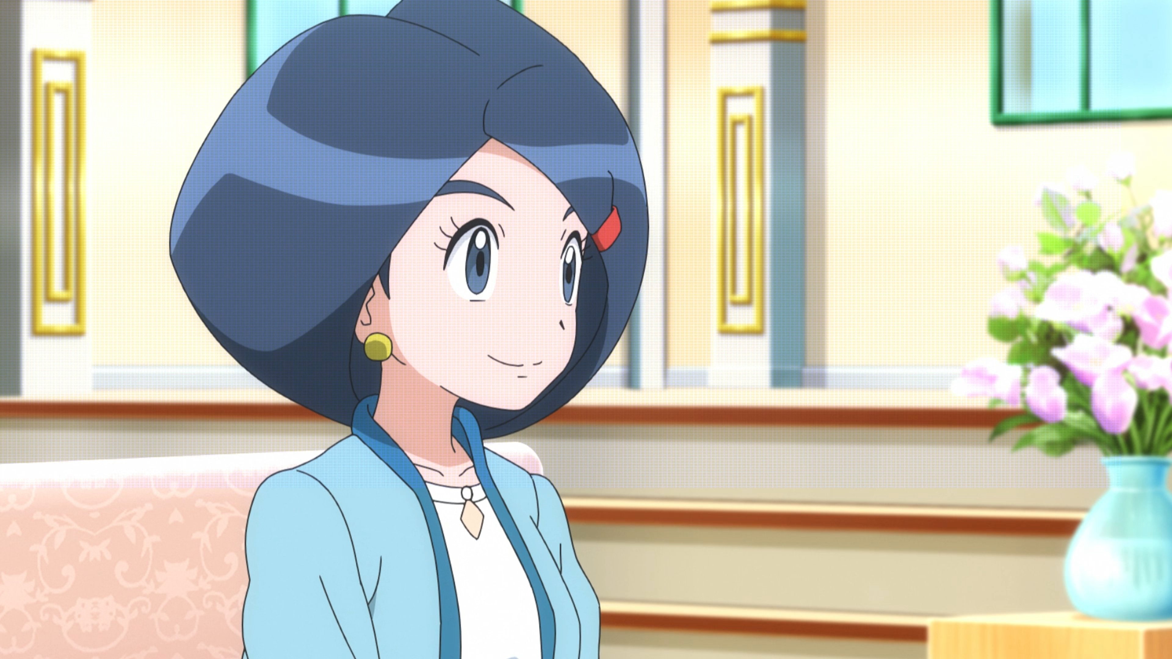 A young woman with short blue hair wearing a light blue jacket