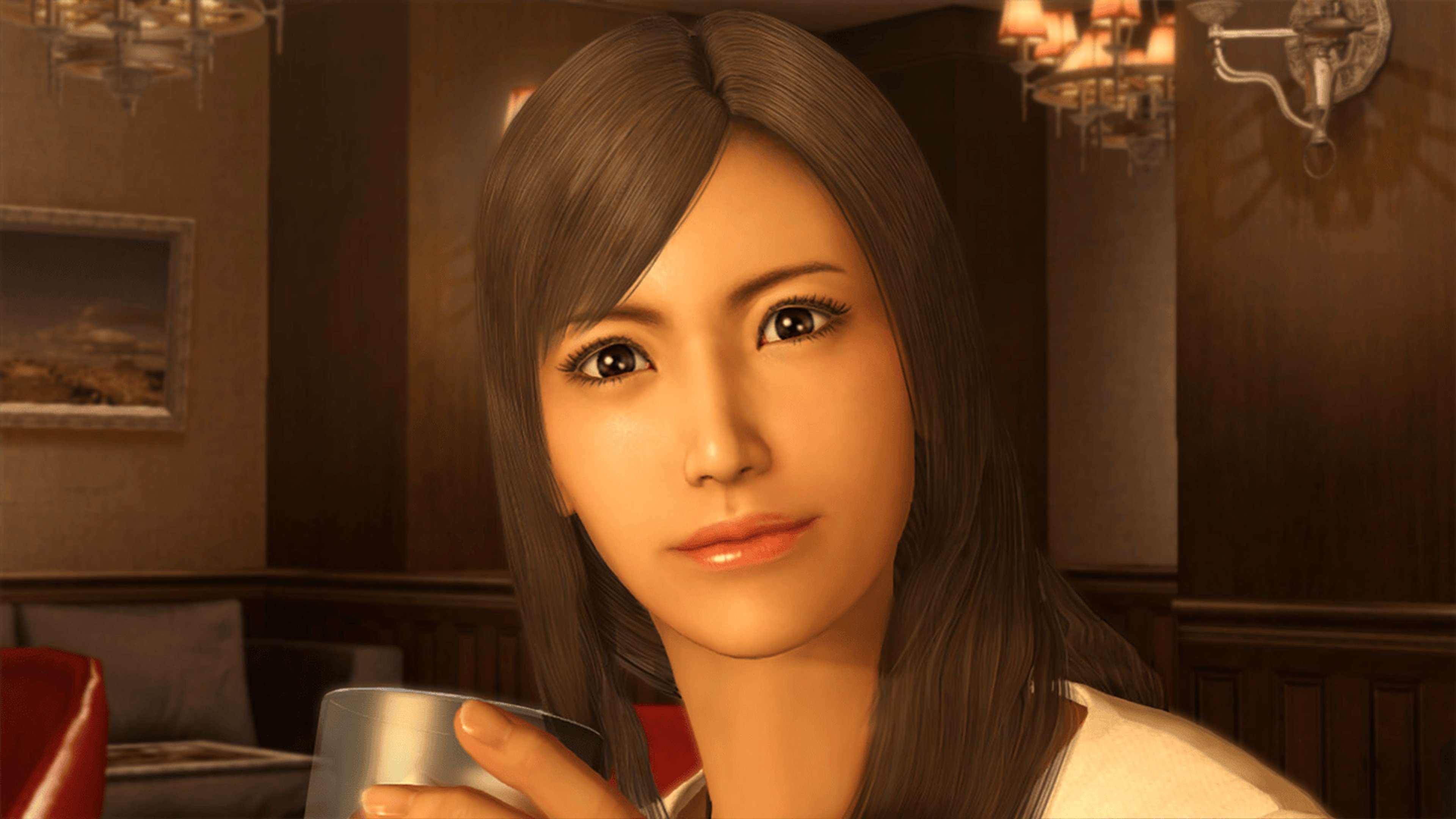 A young woman with long dark hair wearing a white shirt, looking directly at the camera with a gentle expression.