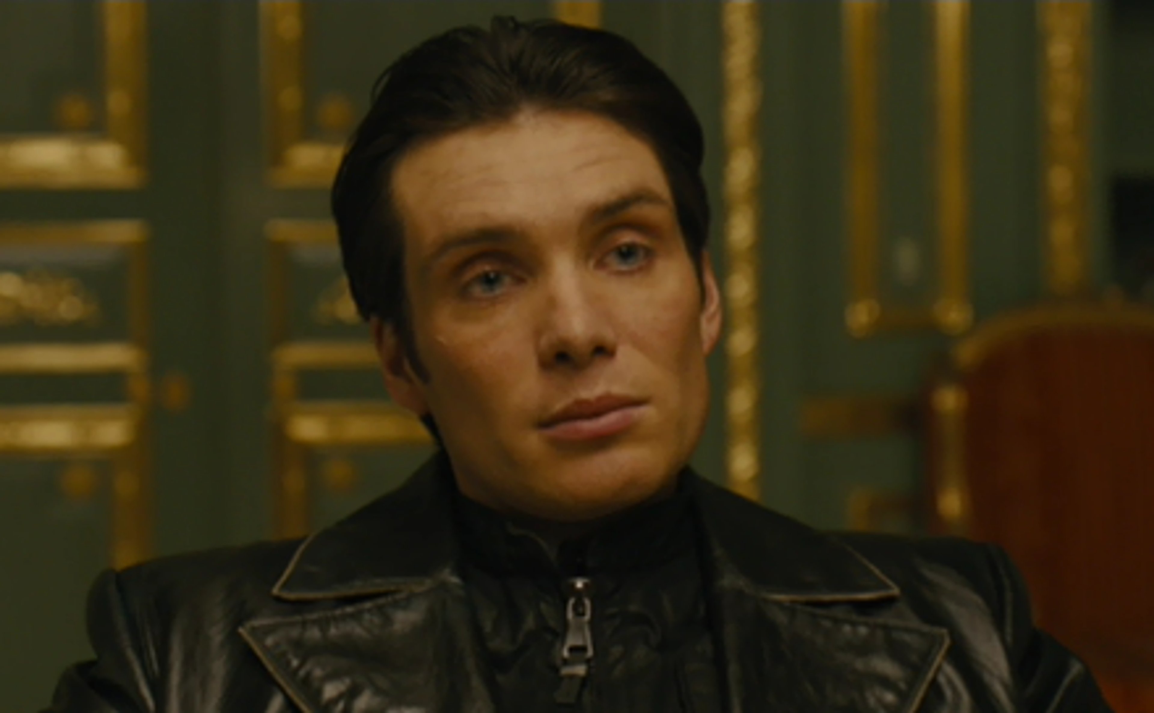 A serious-looking middle-aged man in a black leather jacket