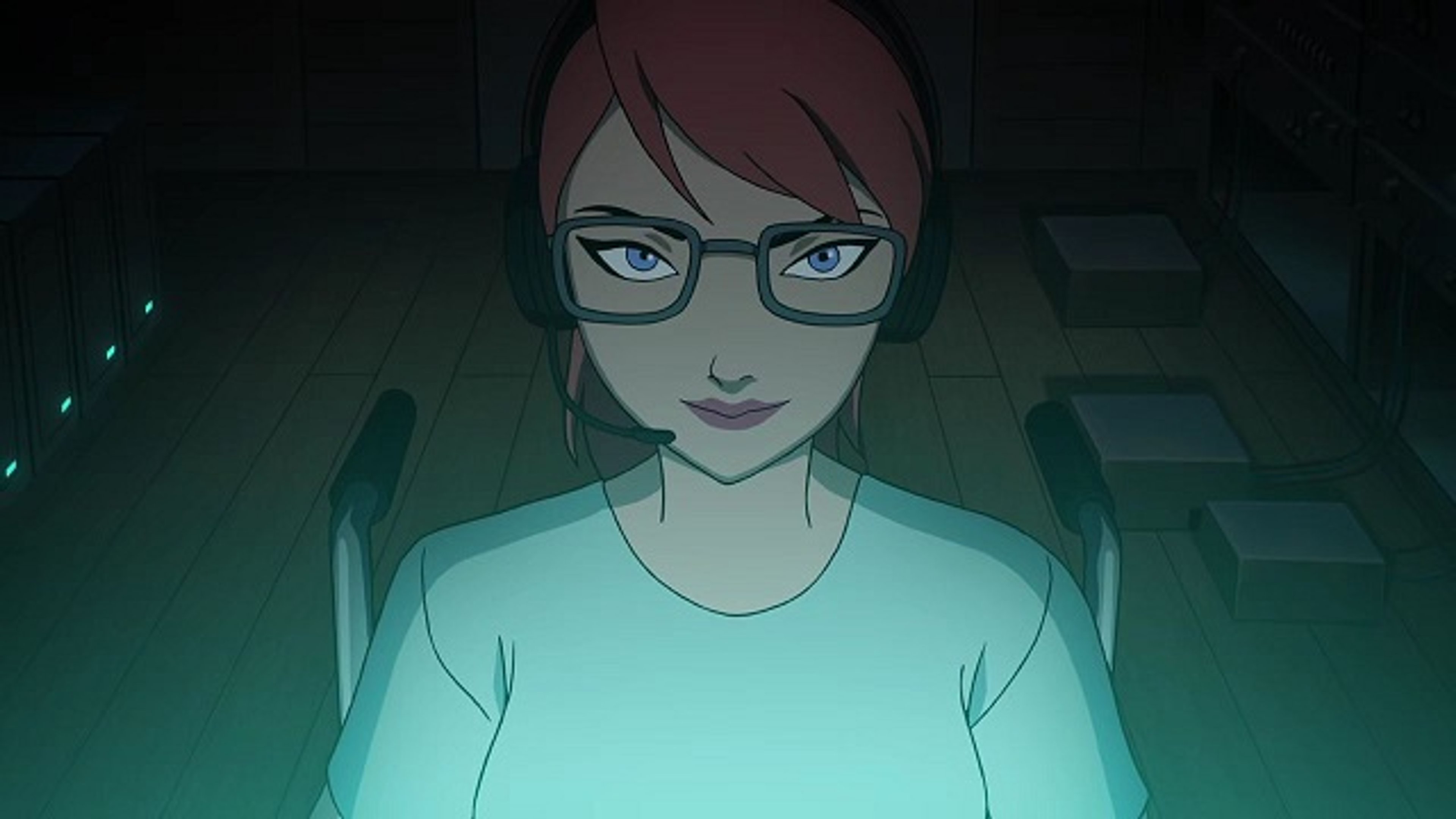A young woman with red hair and glasses in a green shirt