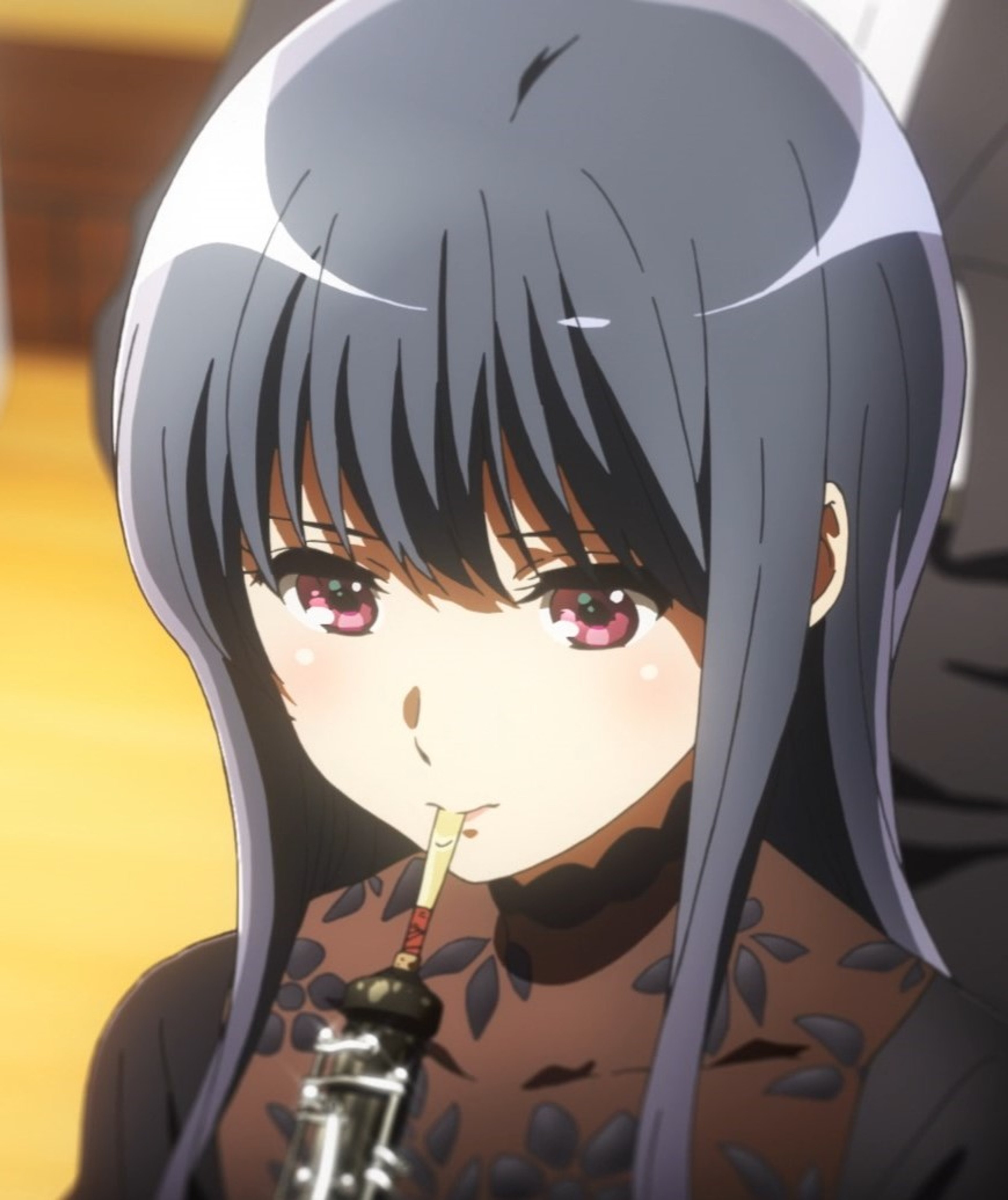 A young woman with blue hair and red eyes, wearing a dark-colored outfit.