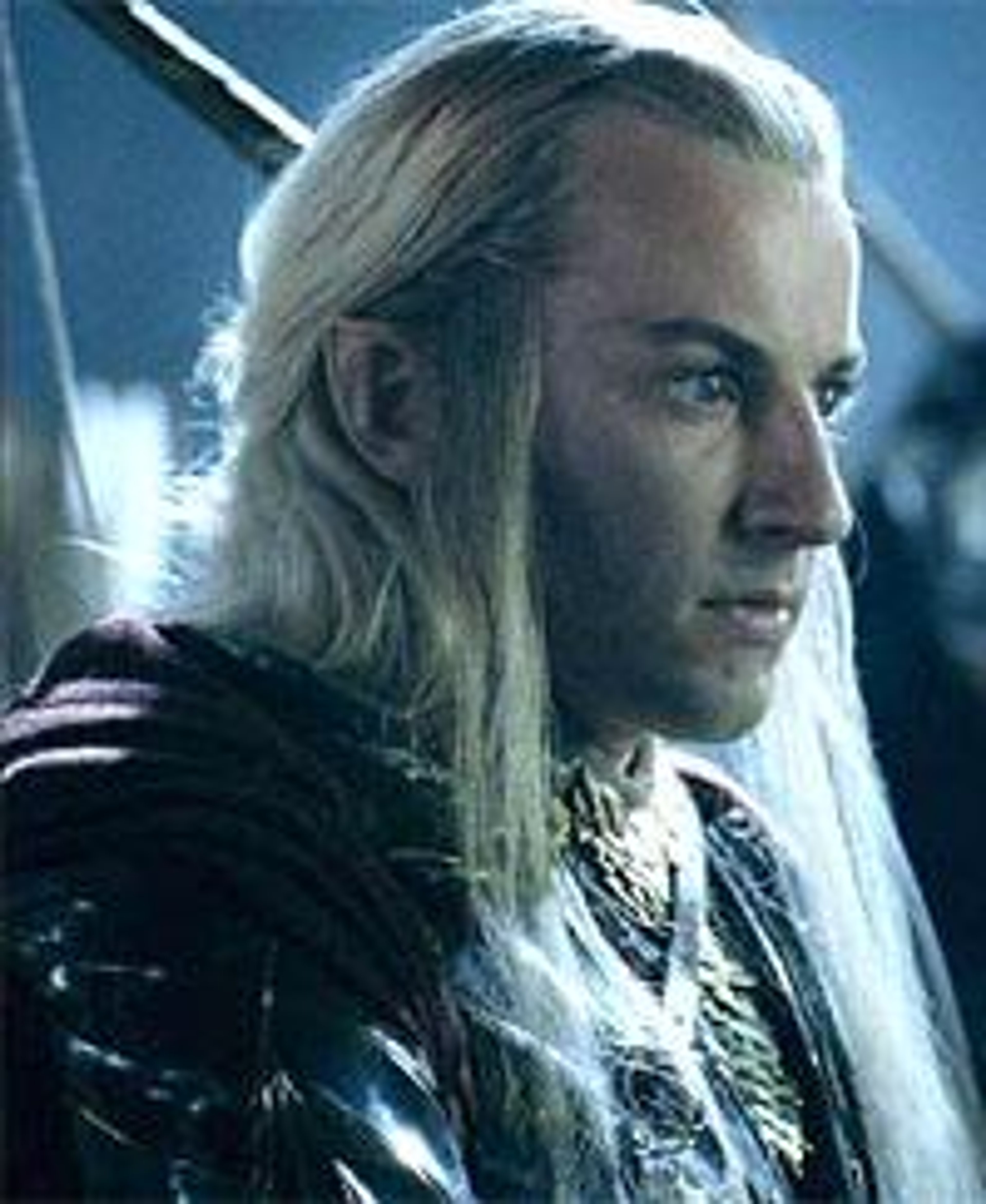 A male Elf character with long blonde hair and a serious expression, wearing a dark cloak.