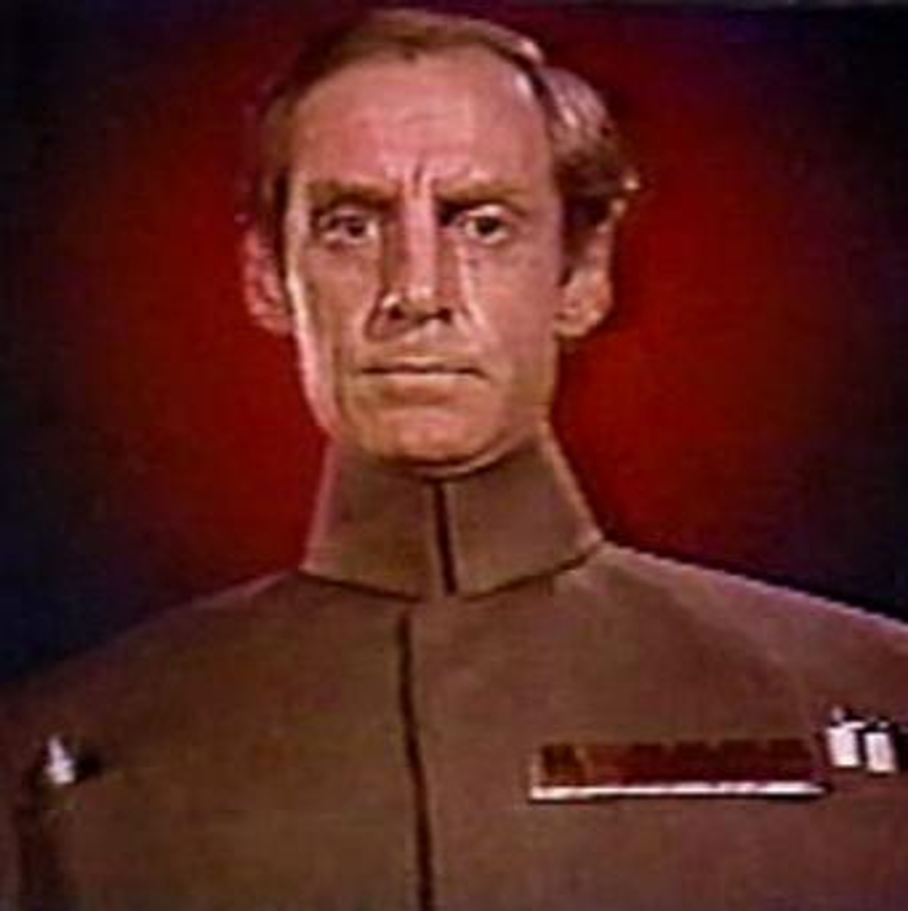 An Imperial officer with a stern expression and commanding presence.