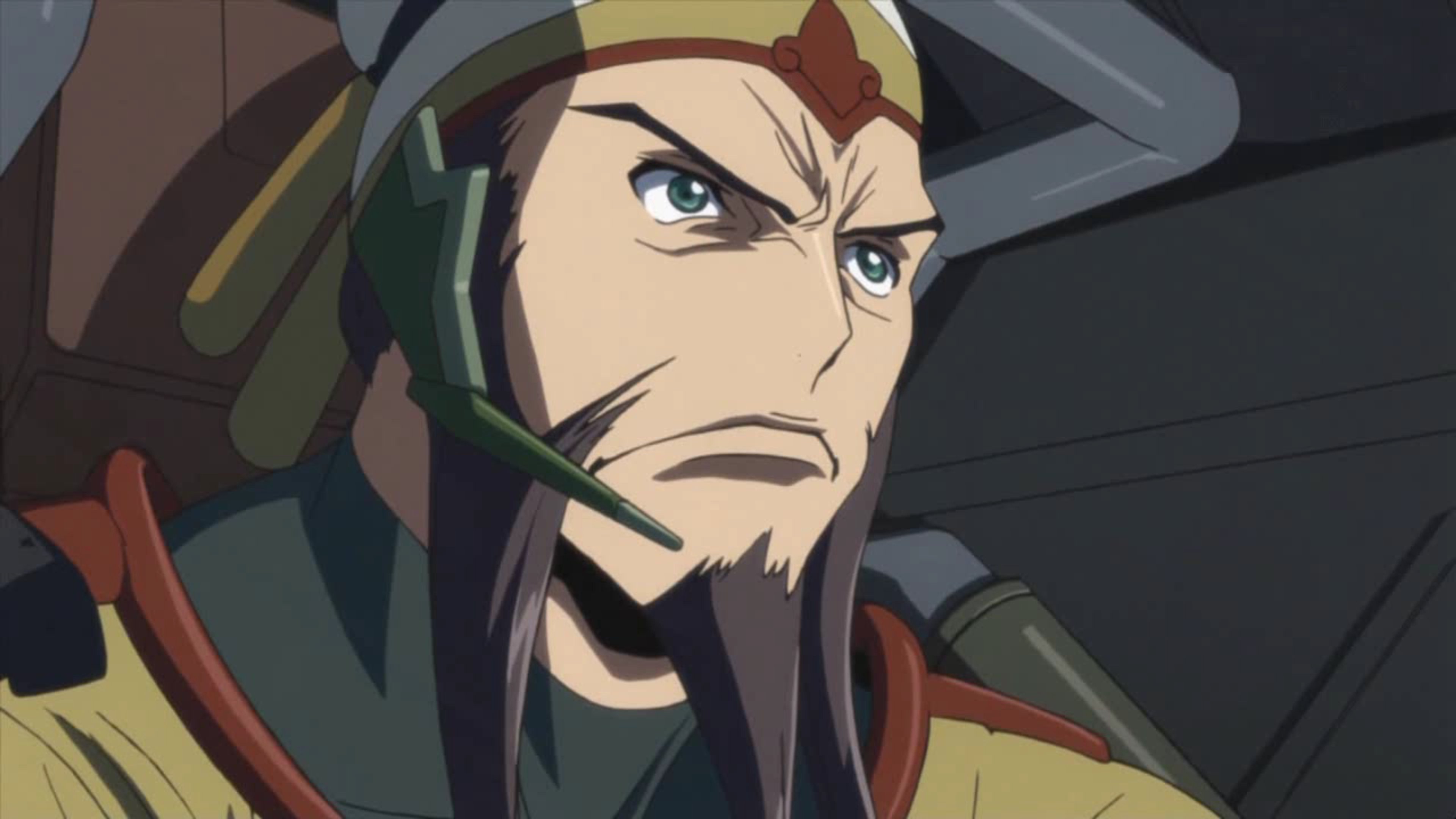 A military officer with a stern expression wearing a uniform with insignia