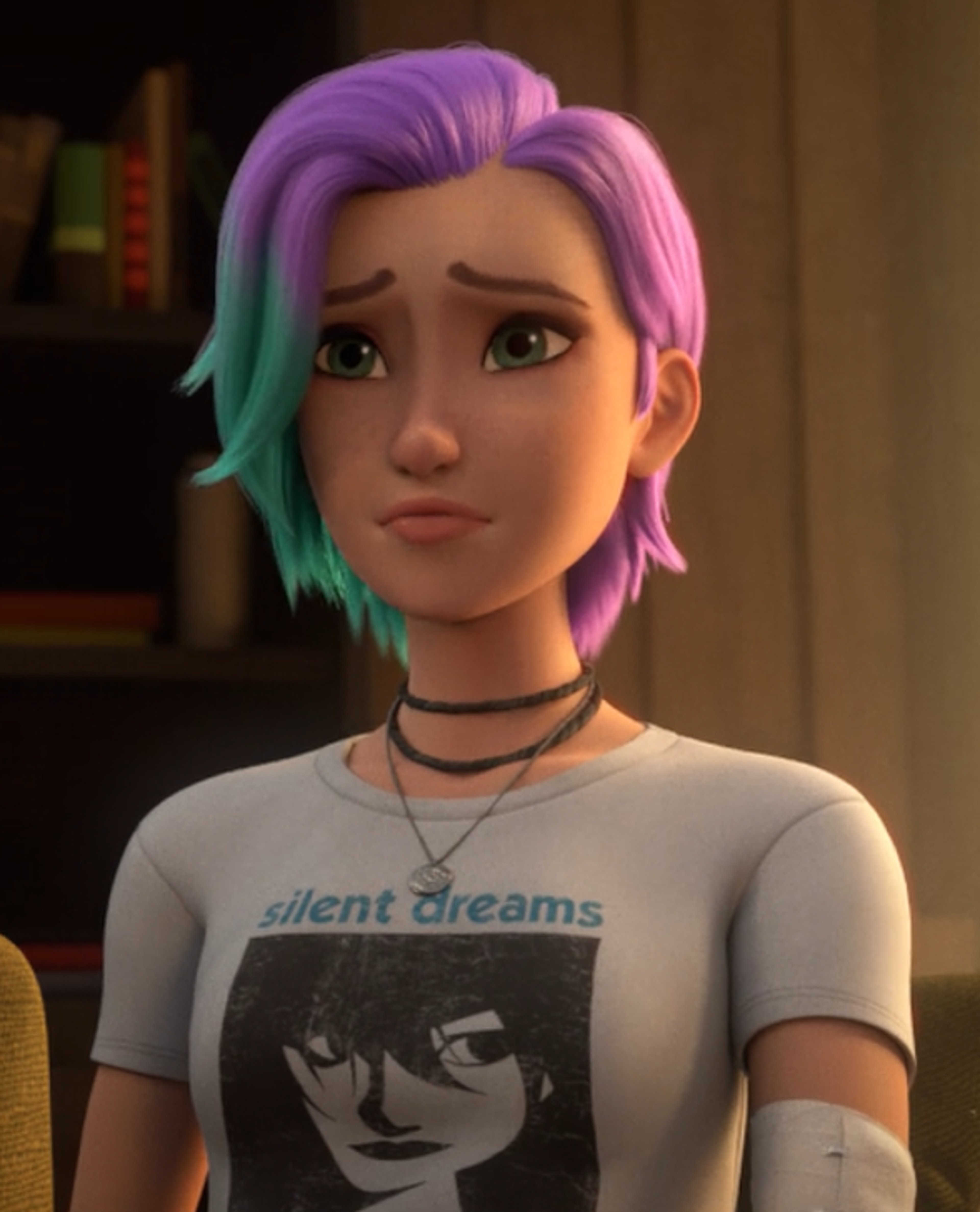 A young woman with colorful hair wearing a graphic t-shirt