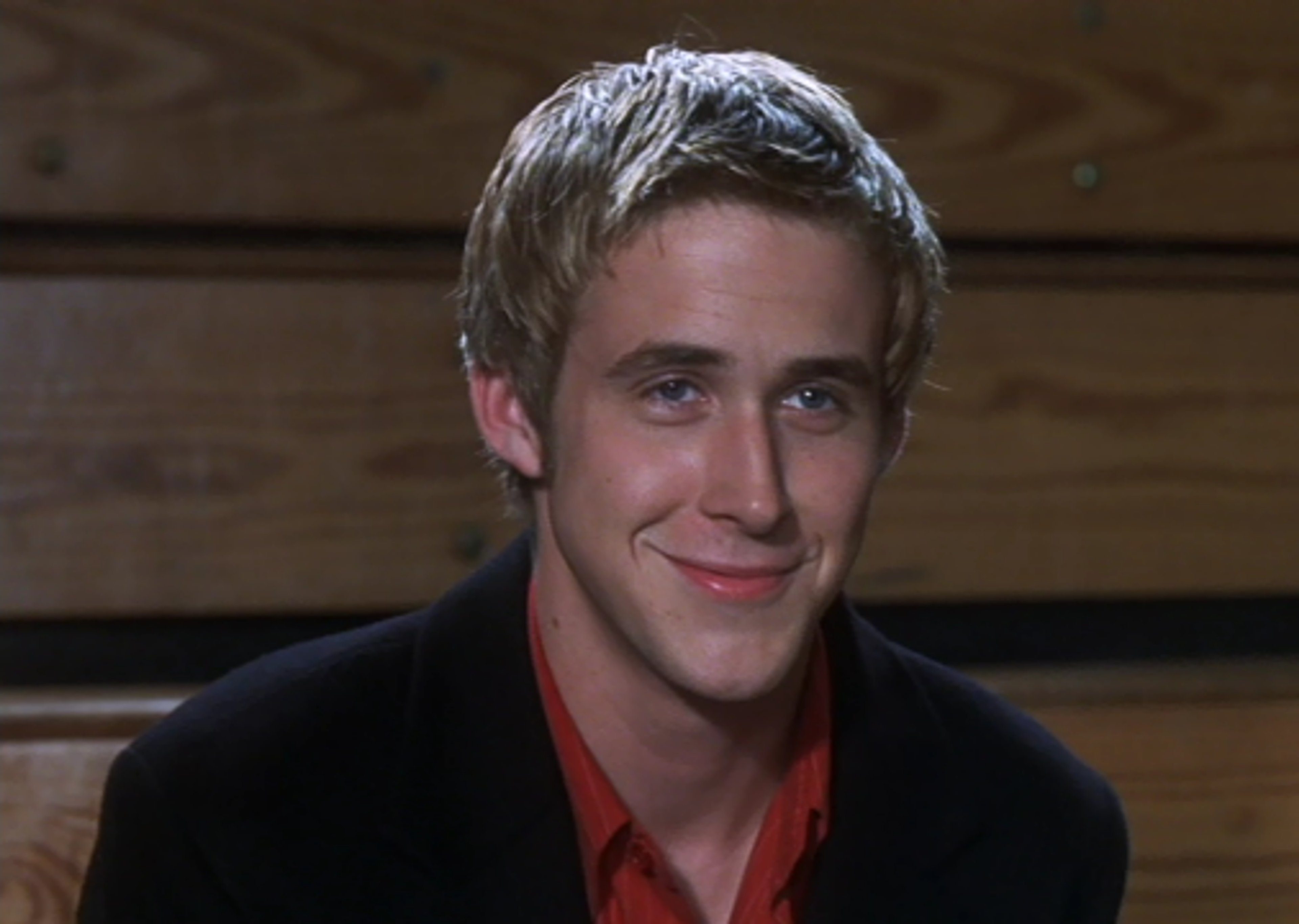 A young man with blond hair and a charming smile
