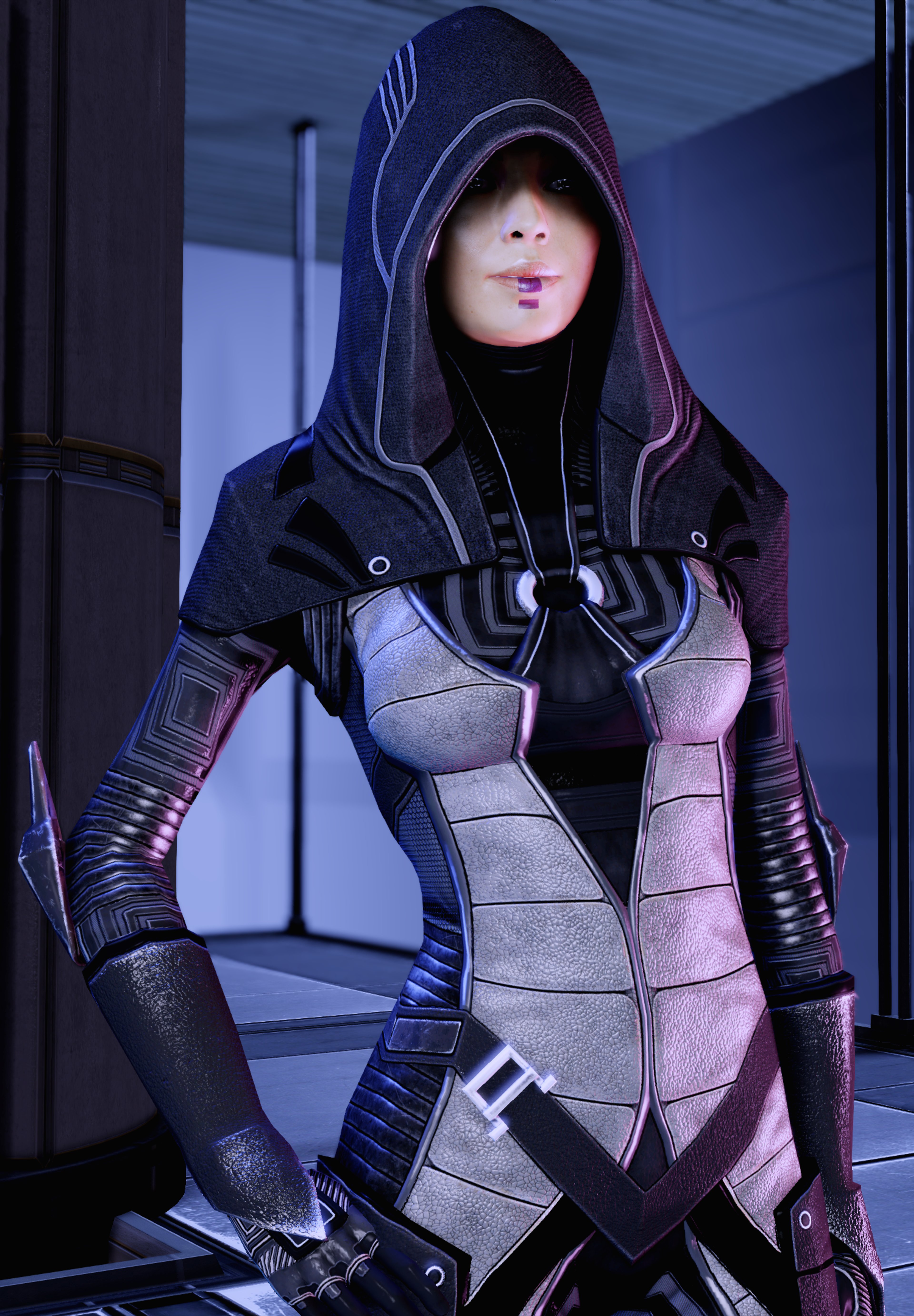 A female character in a dark hooded outfit with armor plating, standing in a dimly lit industrial environment.