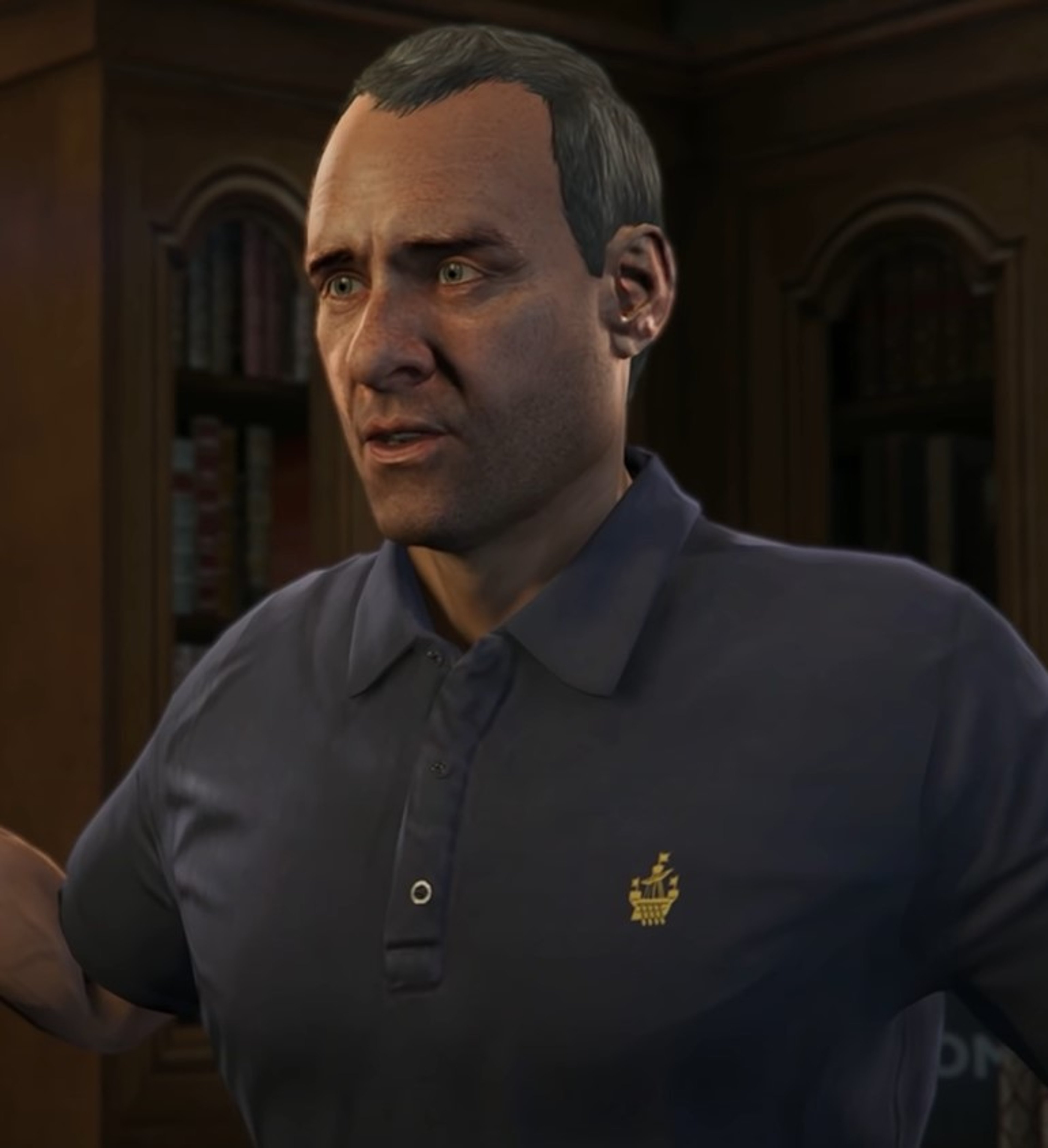 A middle-aged man in a navy blue polo shirt with a serious expression