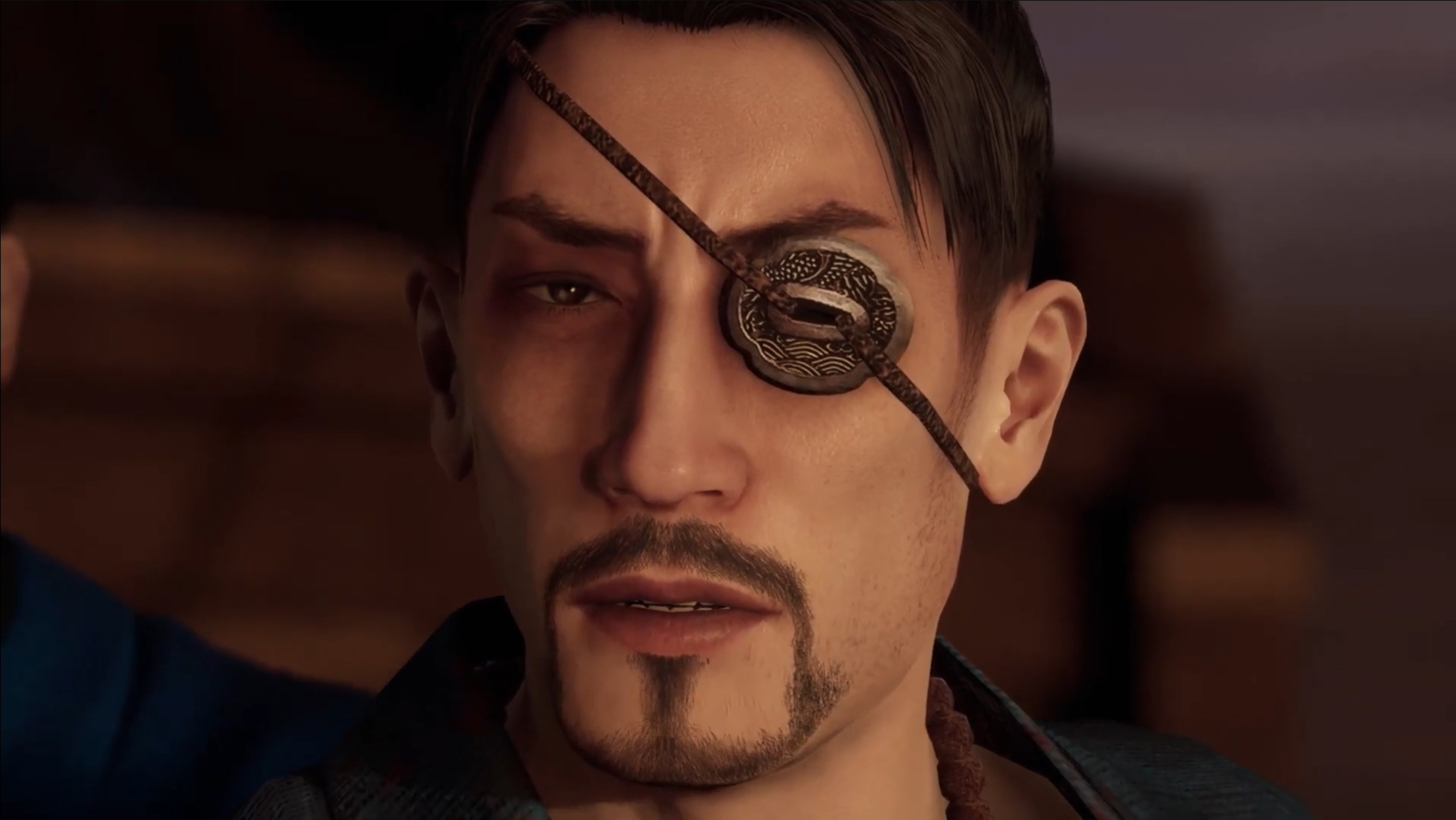 A man with a scar over his left eye, wearing a blue outfit and having a serious expression