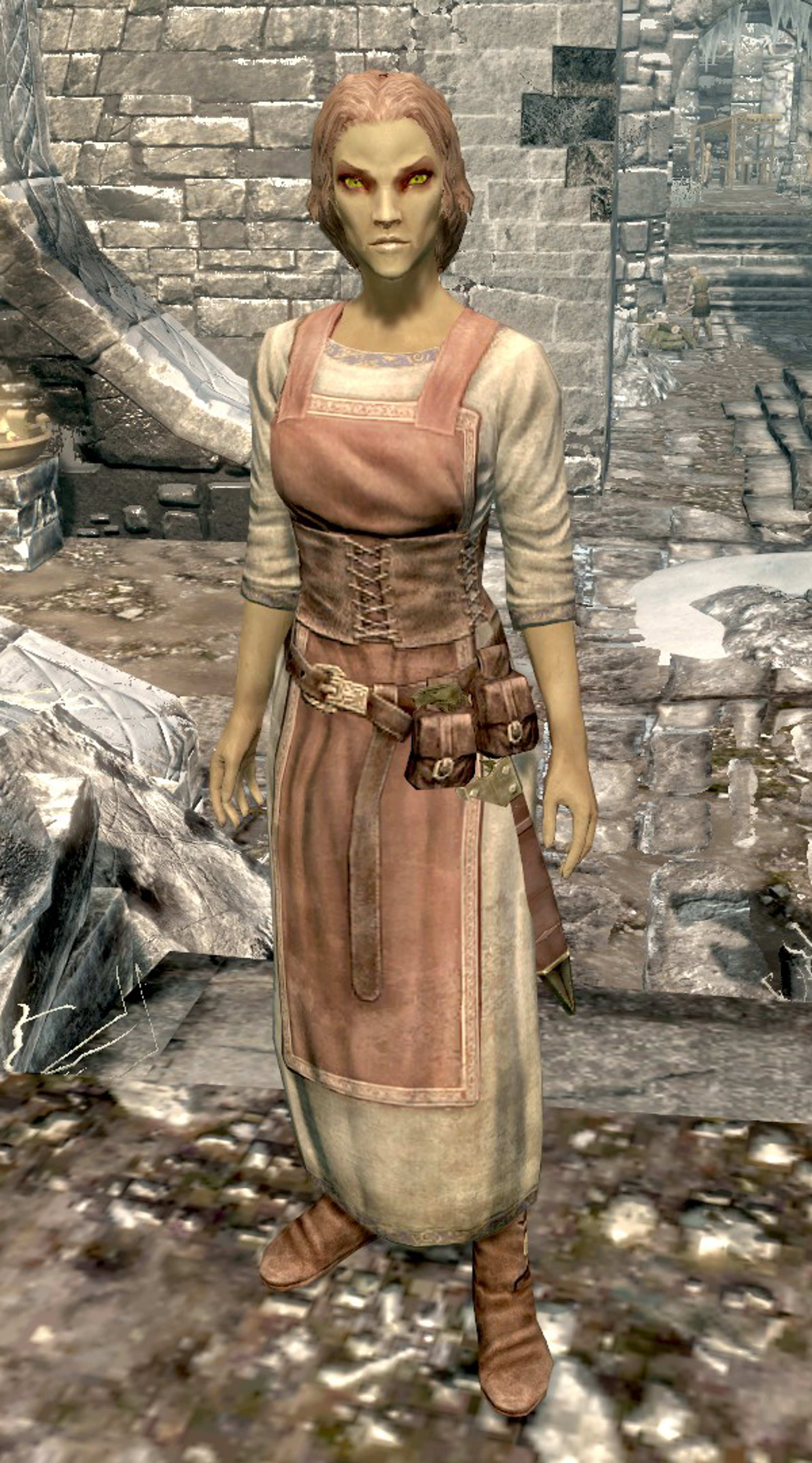 An Altmer woman in a pink dress standing in a rugged outdoor environment