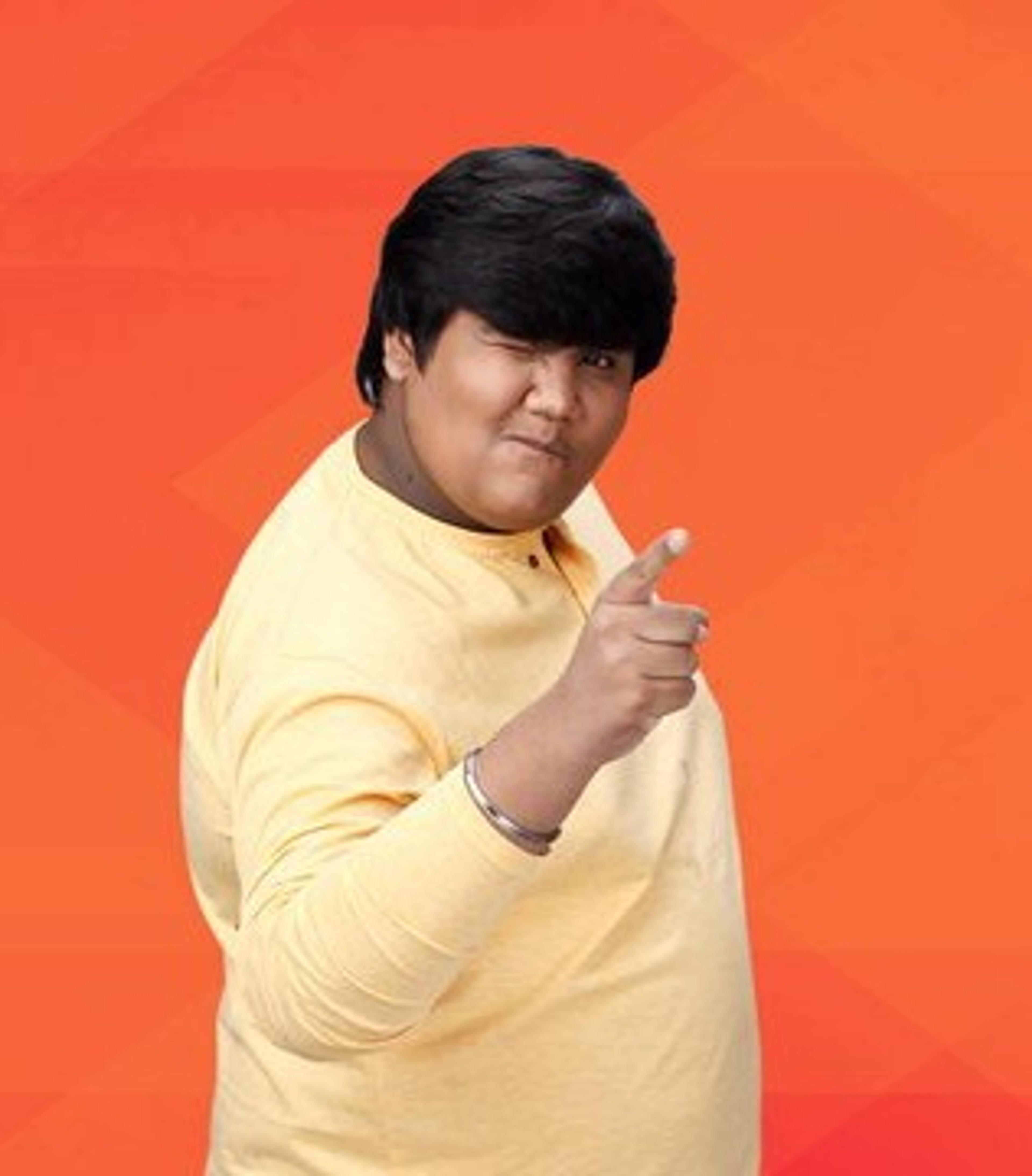 A man in a yellow shirt gesturing against an orange background