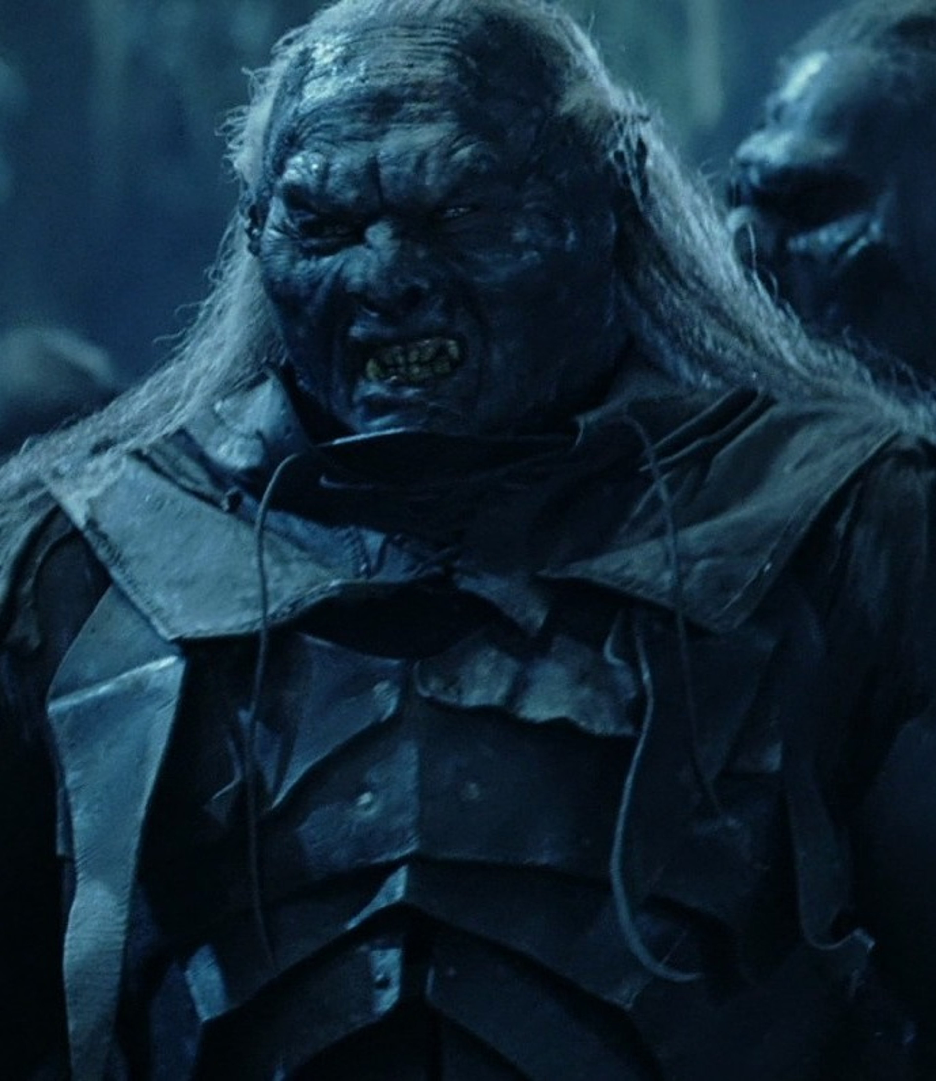 A fierce, brutish-looking Uruk-hai warrior with a hulking, muscular frame and jagged teeth.