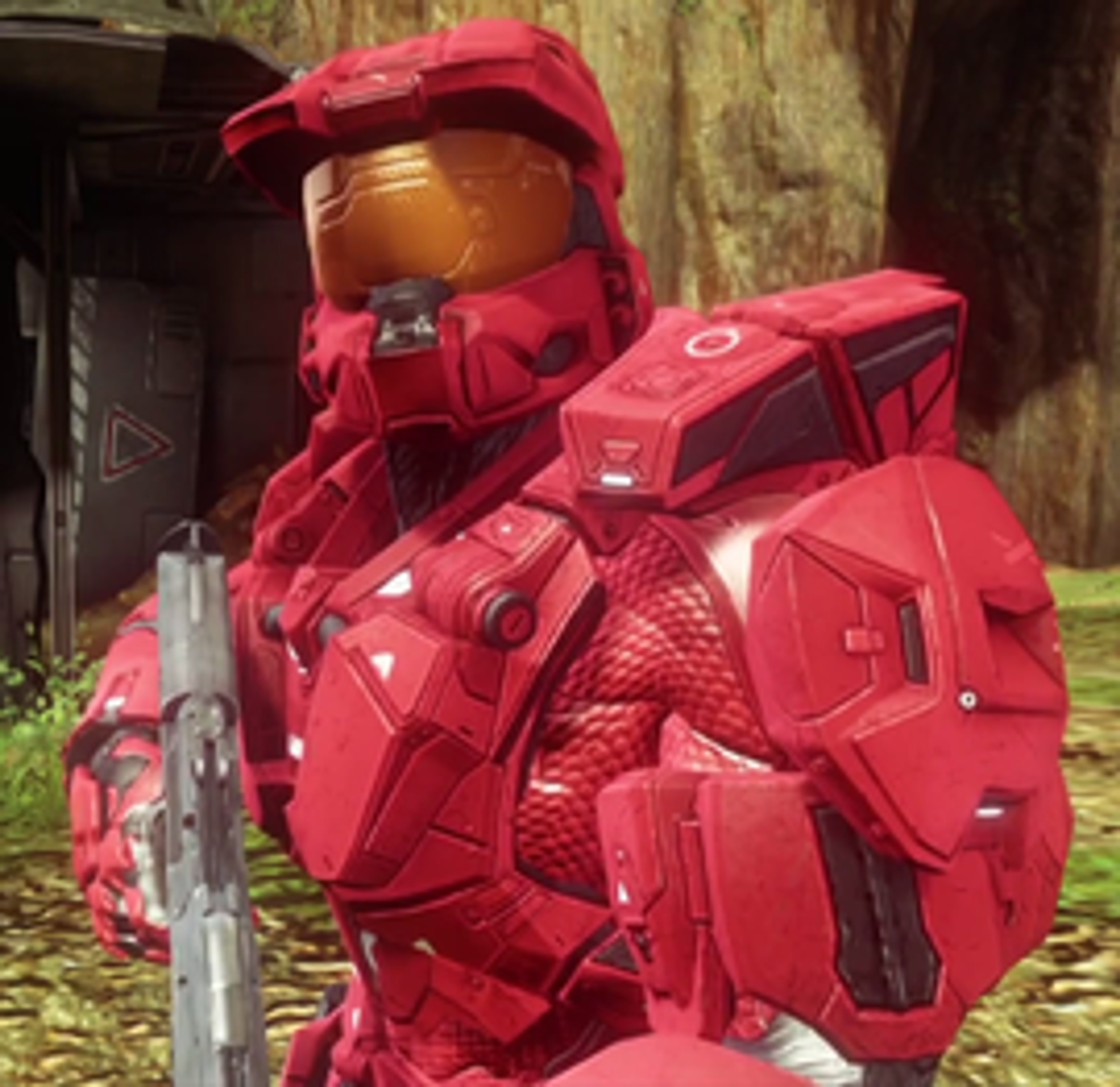 A heavily armored military character in red armor, holding a weapon or device.