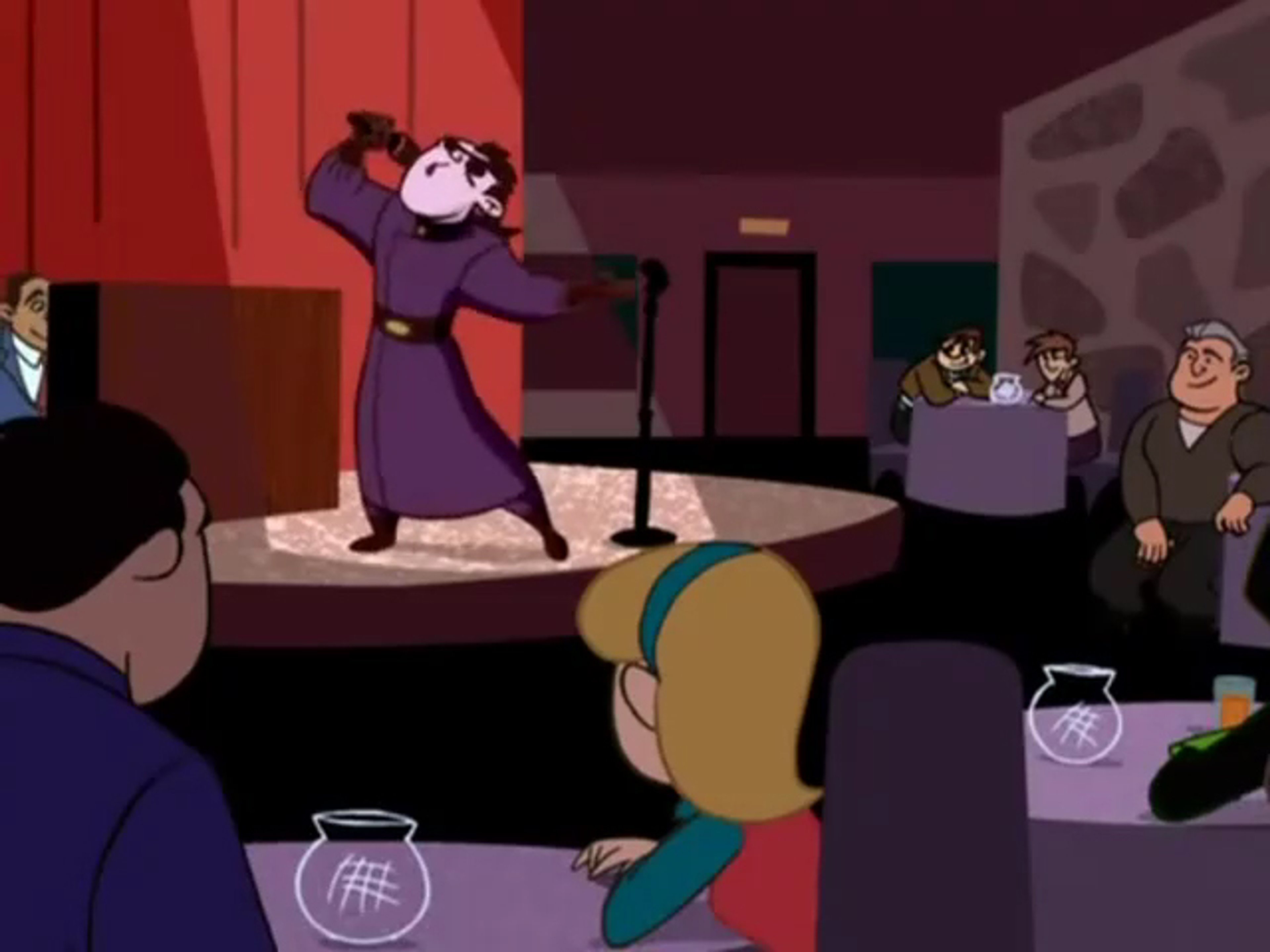 A blue-skinned mad scientist character performing on a stage