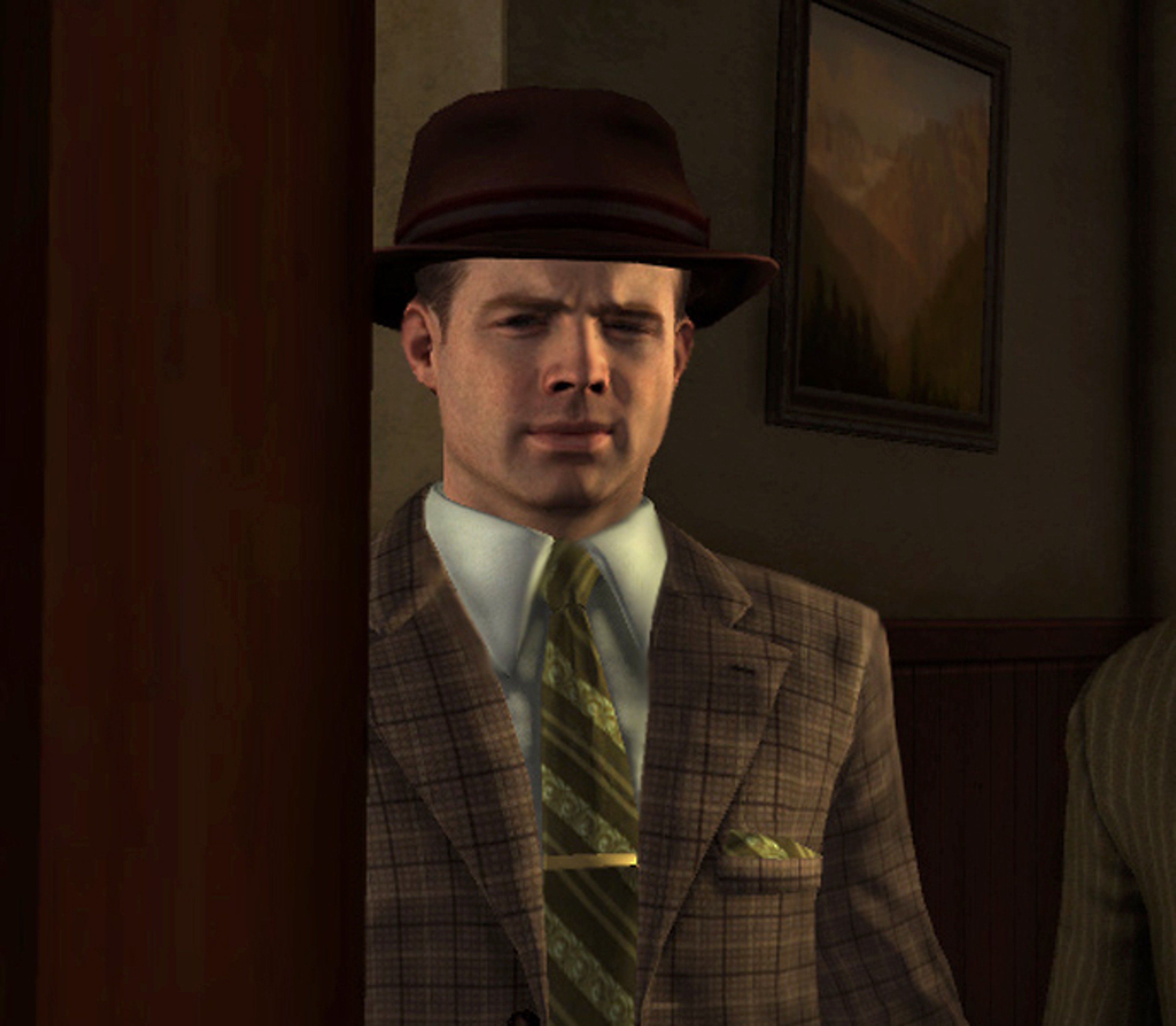 A man in a suit and hat with a serious expression, likely a detective or law enforcement officer