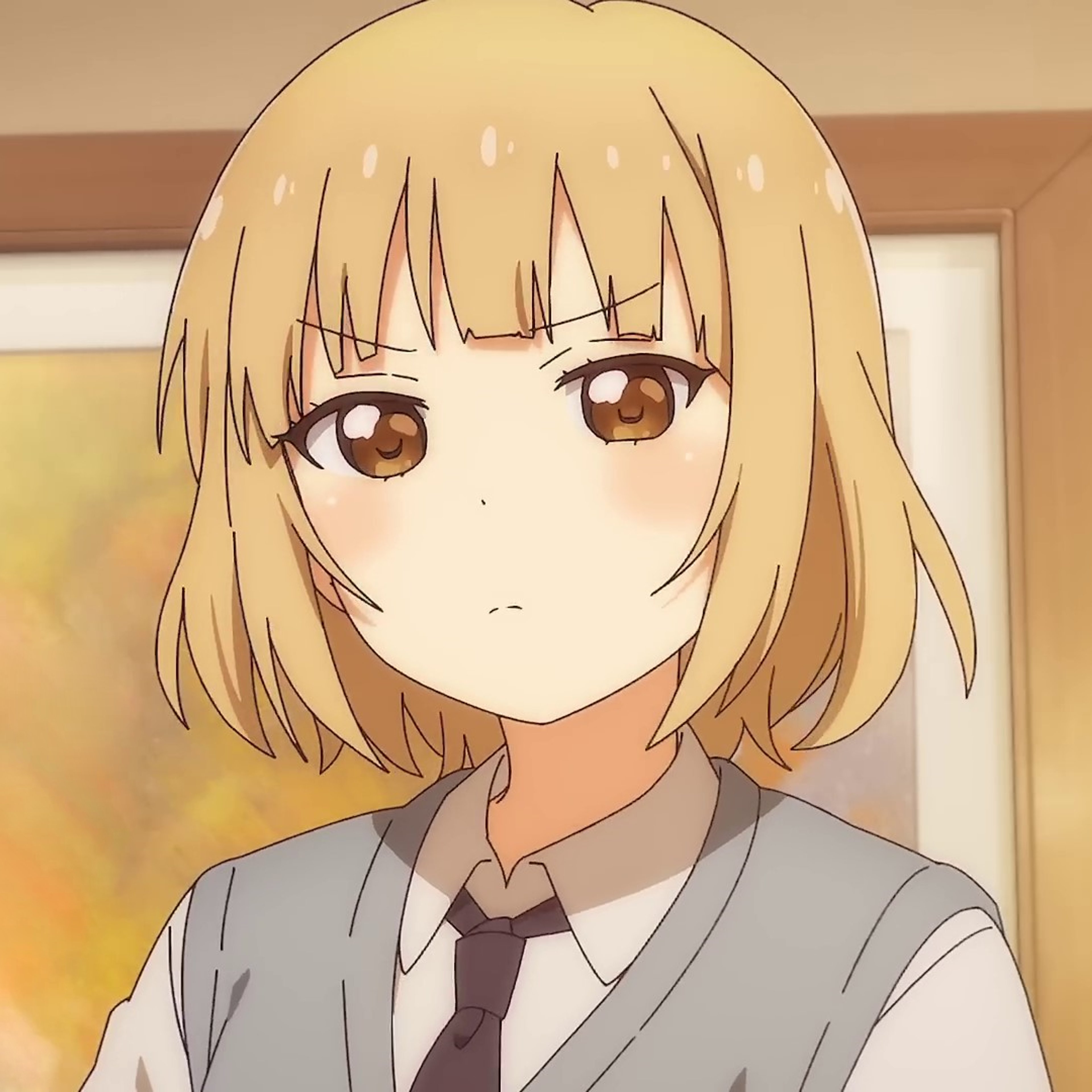 An anime-style character with blonde hair and brown eyes wearing a gray school uniform