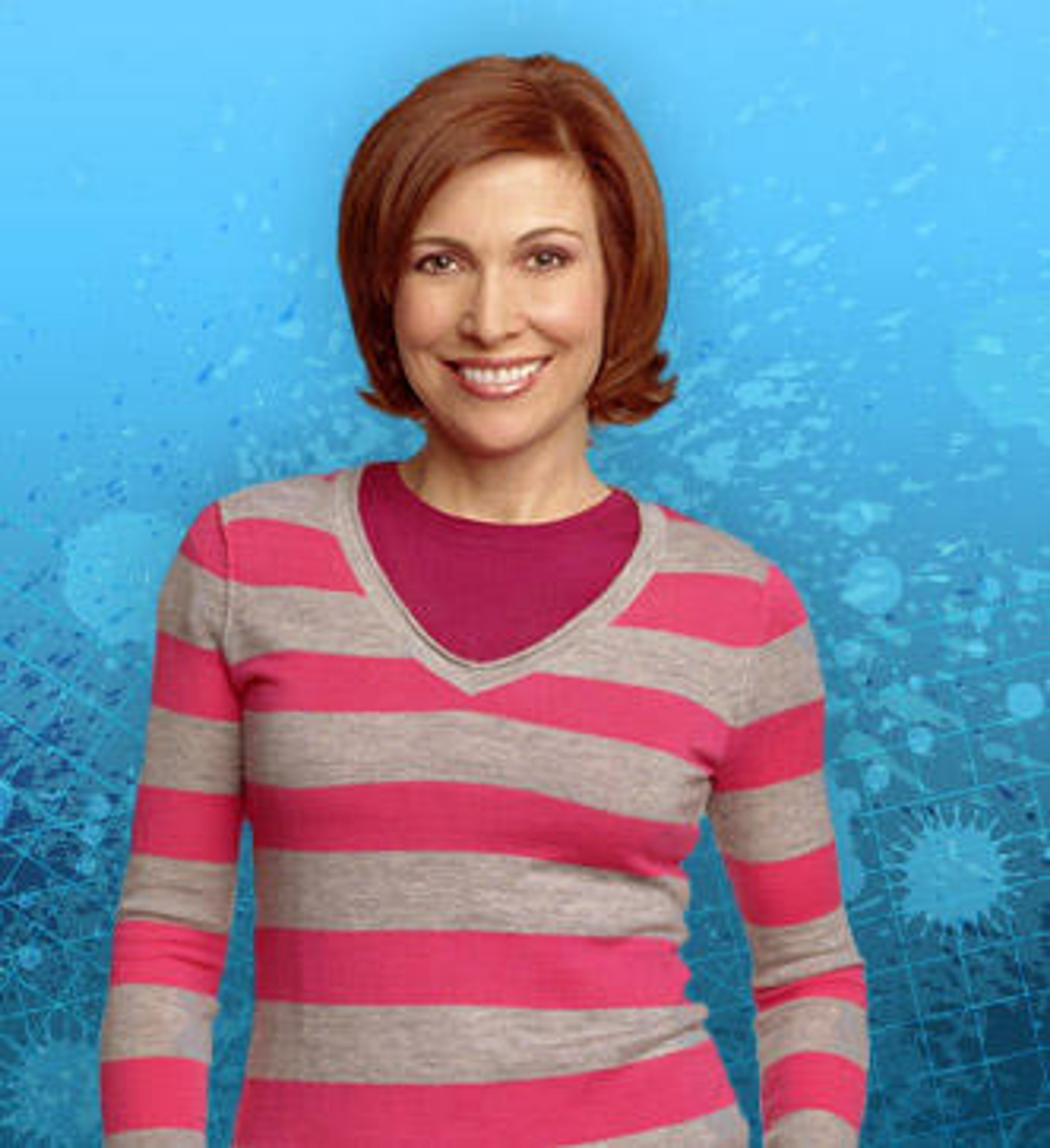 A middle-aged woman with short, reddish-brown hair wearing a pink and gray striped sweater, smiling at the camera.