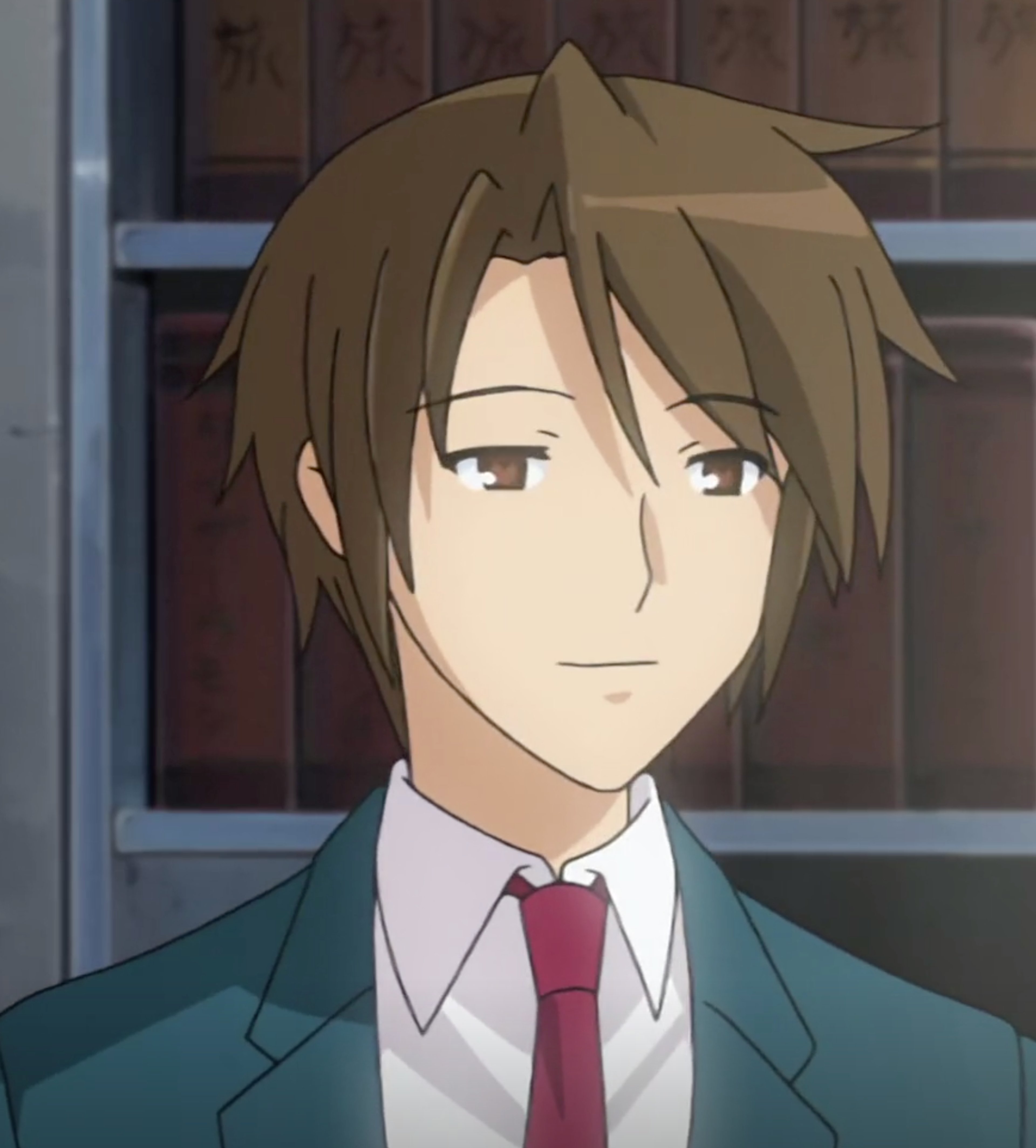 A young man with short brown hair wearing a green school uniform and red tie