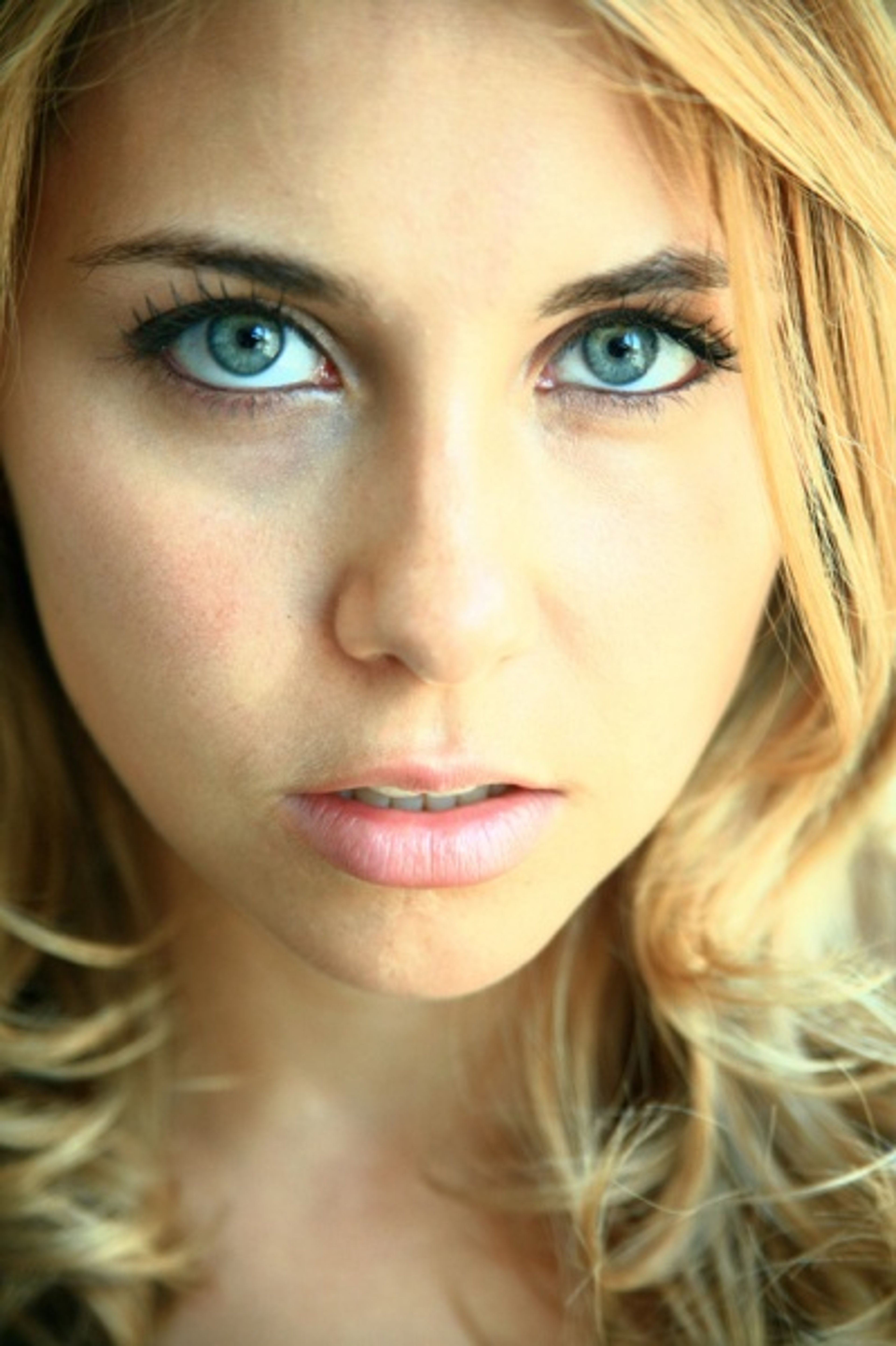 Portrait of a young woman with blonde hair and blue eyes
