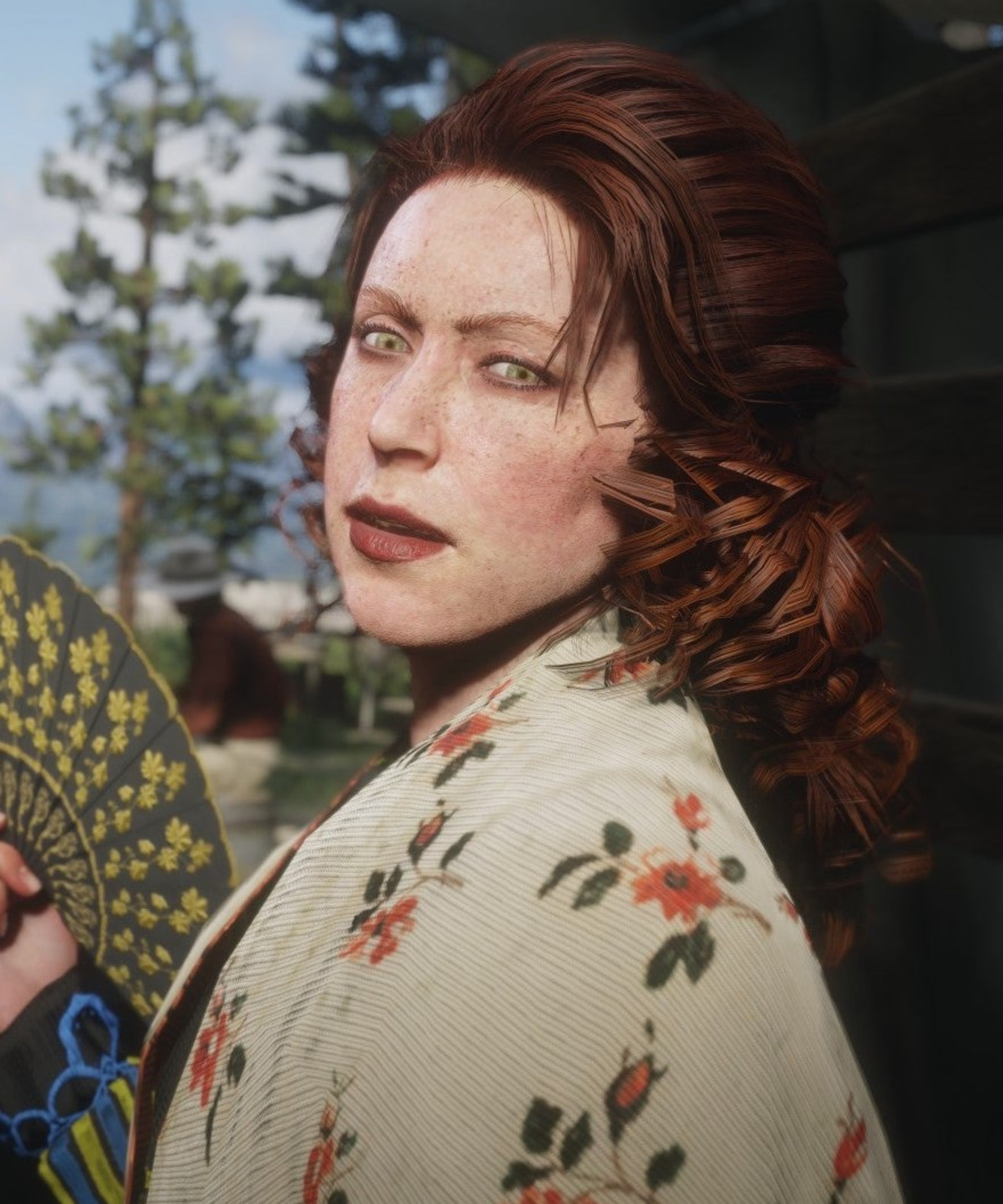 A young woman with long, wavy red hair wearing a floral-patterned shawl, looking off to the side with a serious expression.