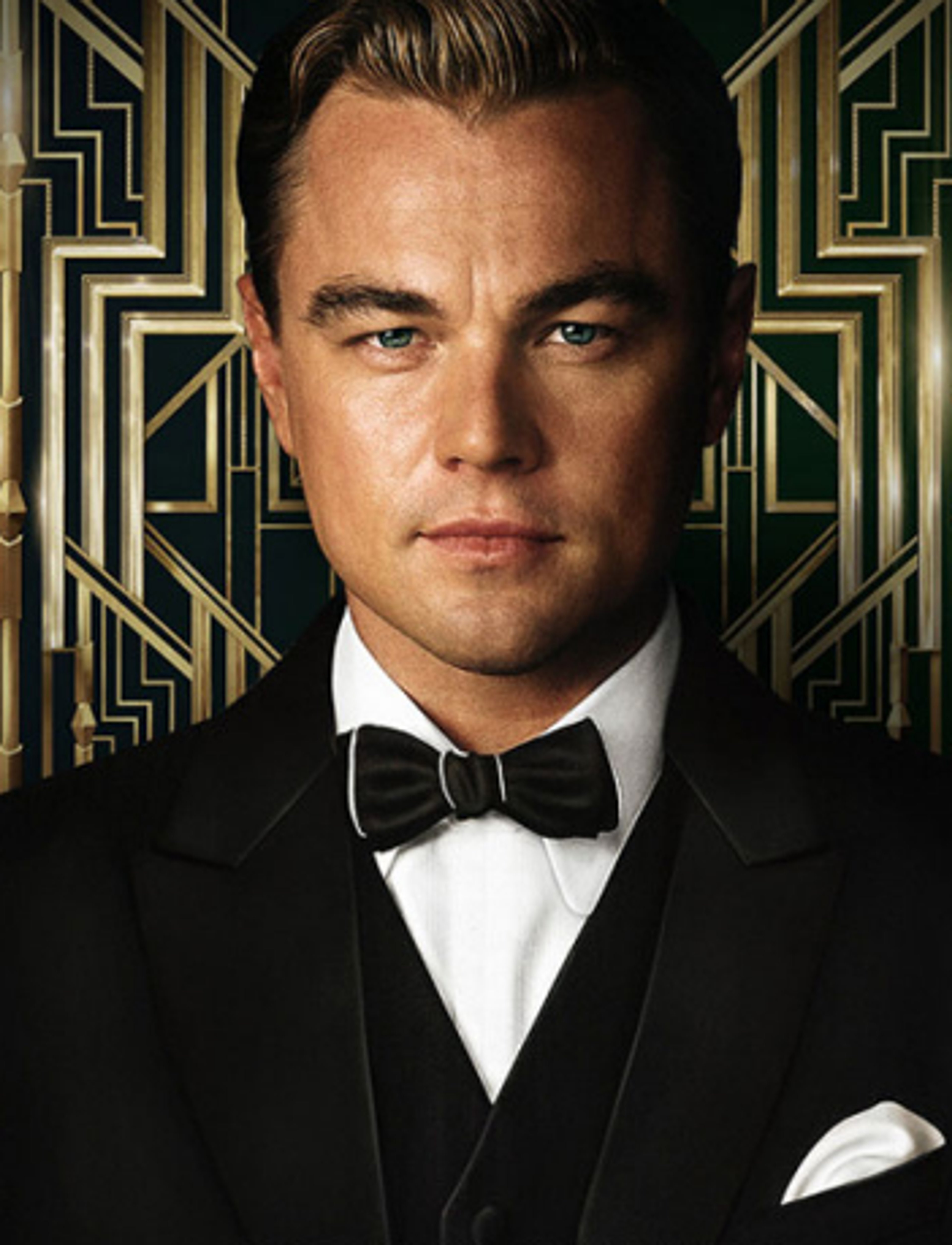 A well-dressed man in a tuxedo with slicked-back blond hair and a serious expression, set against an Art Deco-style background.