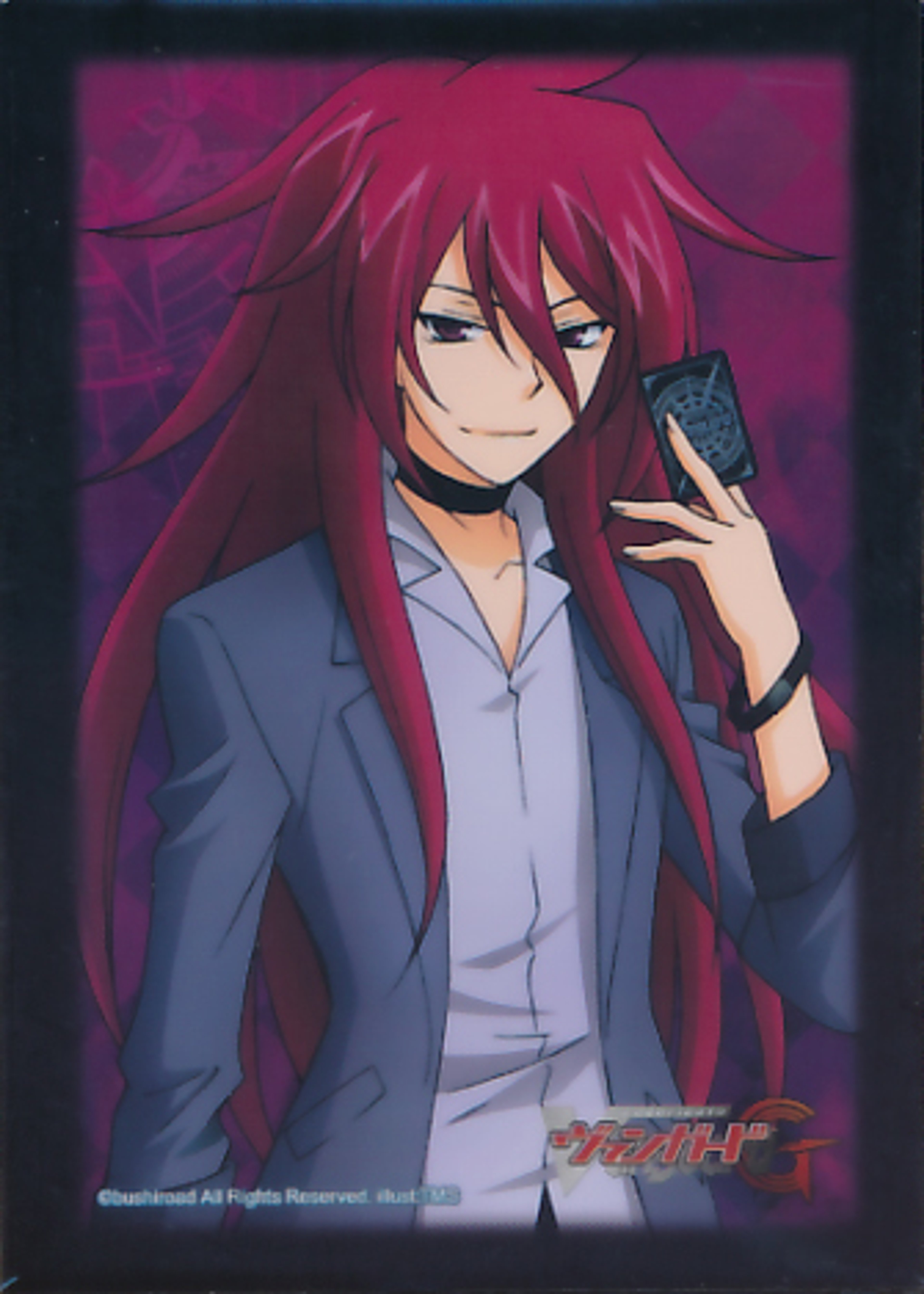 A young man with red hair wearing a gray suit and holding a mobile phone