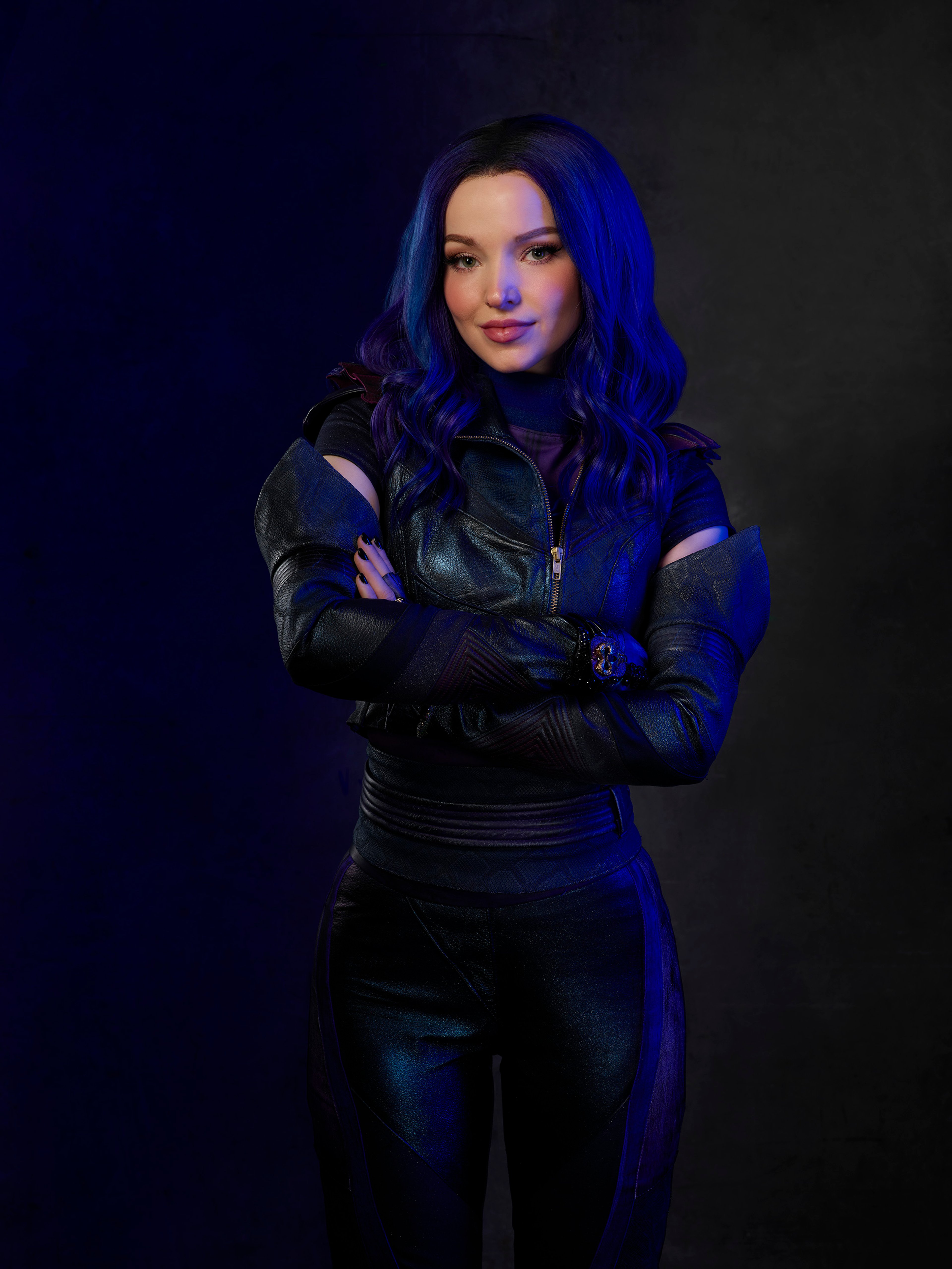 A young woman with purple hair and green eyes wearing a black leather jacket