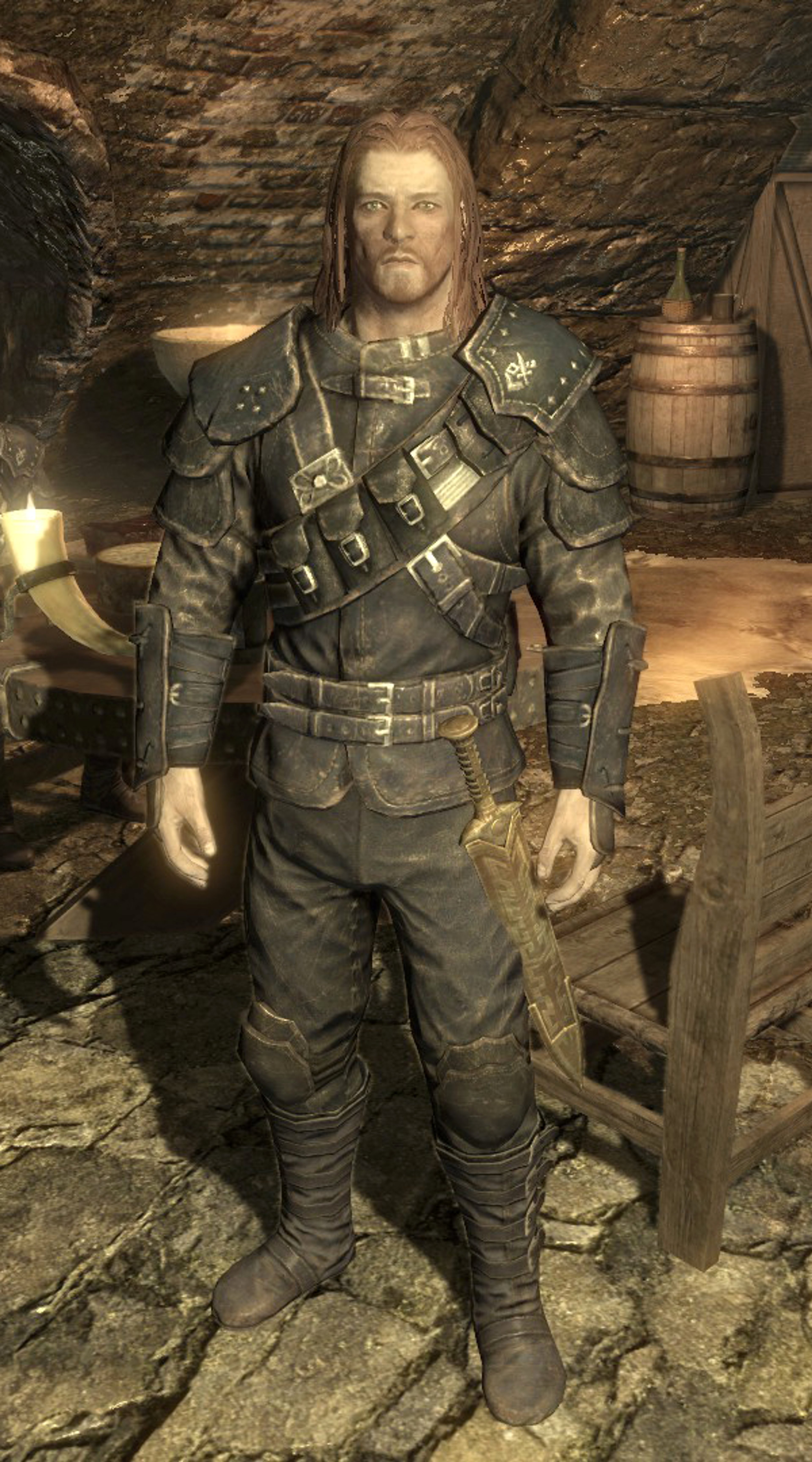 A Nord man in a dark leather outfit standing in a cave
