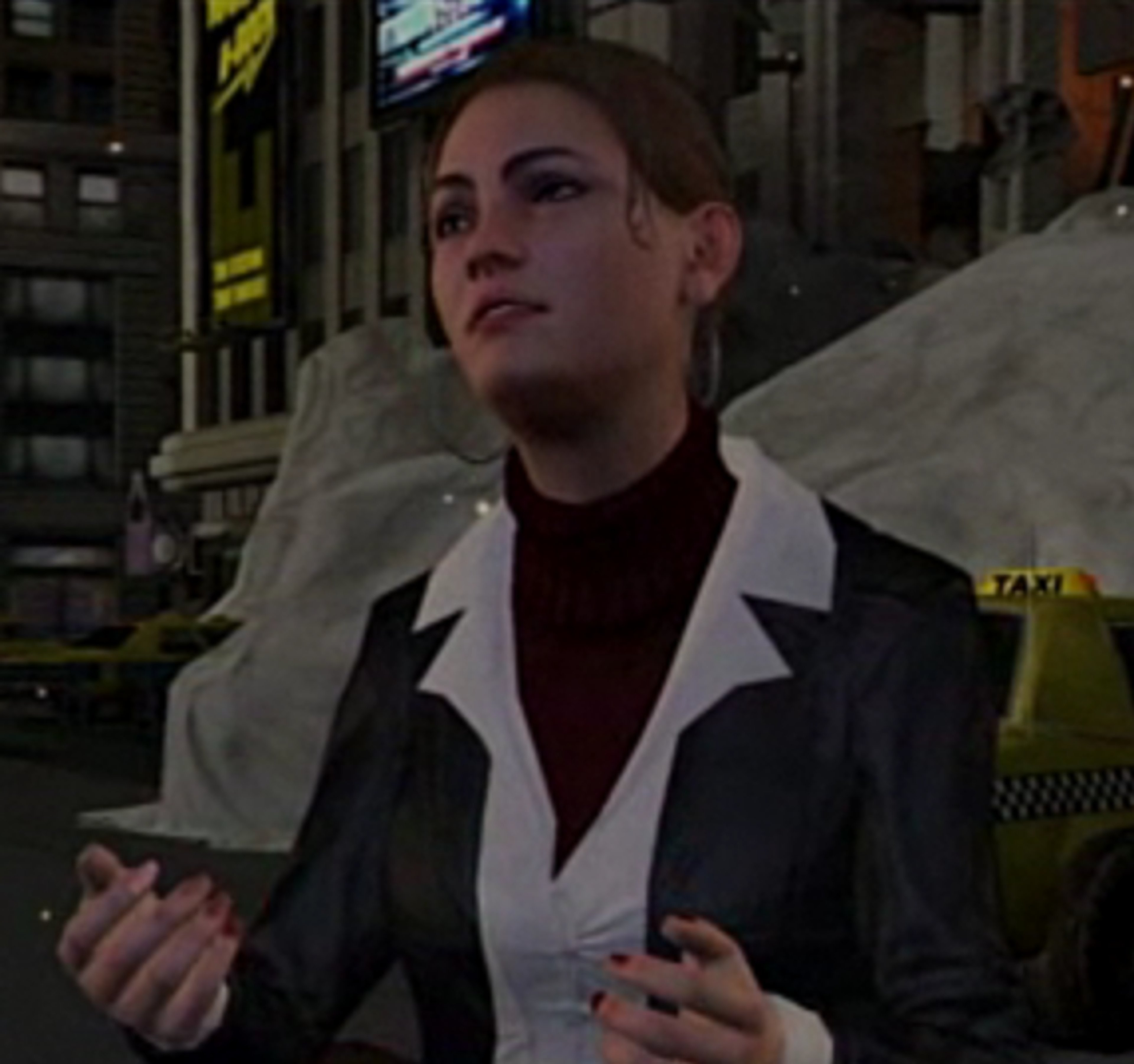 A woman with brown hair wearing a black jacket and turtleneck sweater in a professional setting.