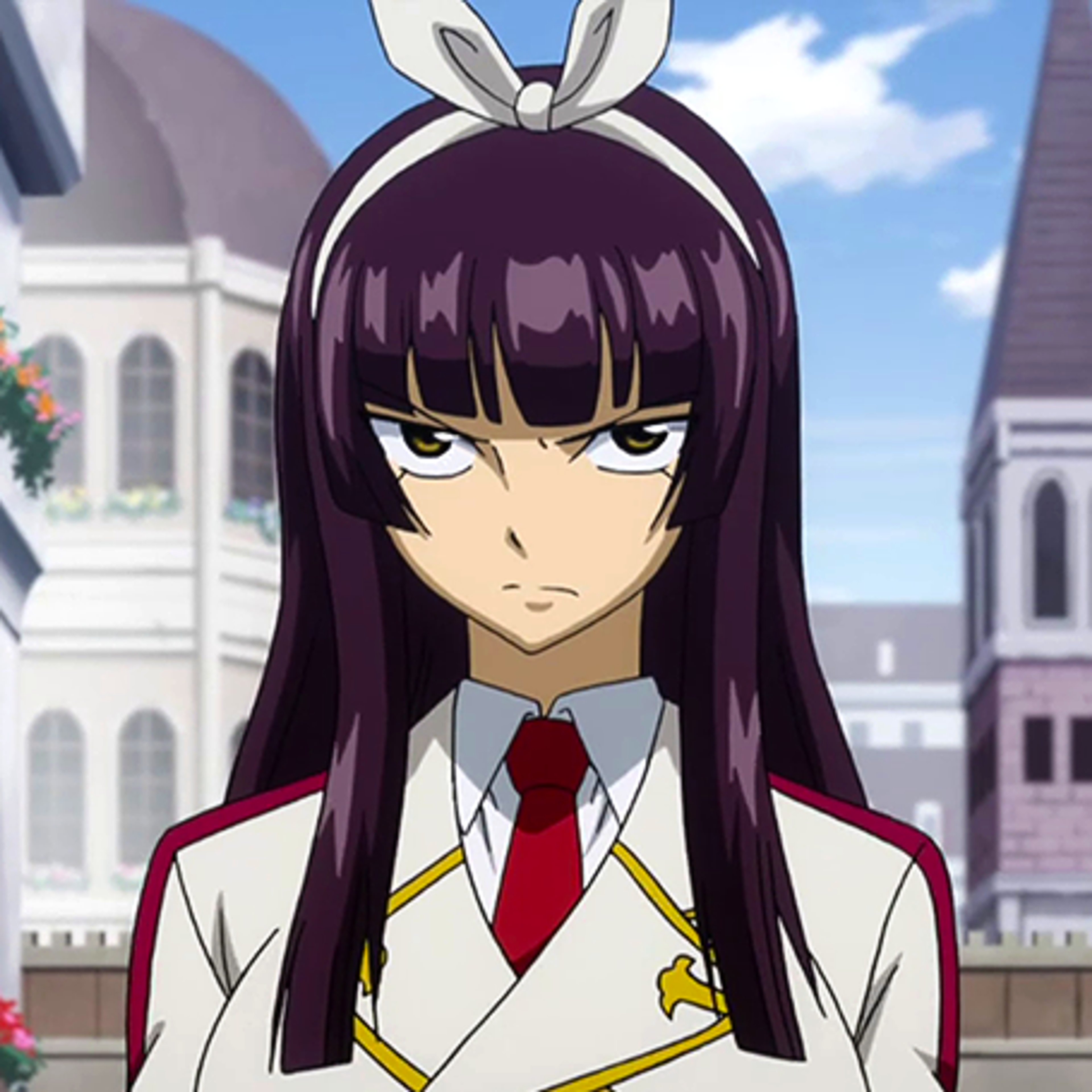 A young woman with long dark hair and brown eyes wearing a white school uniform with a red tie, standing in a city setting.