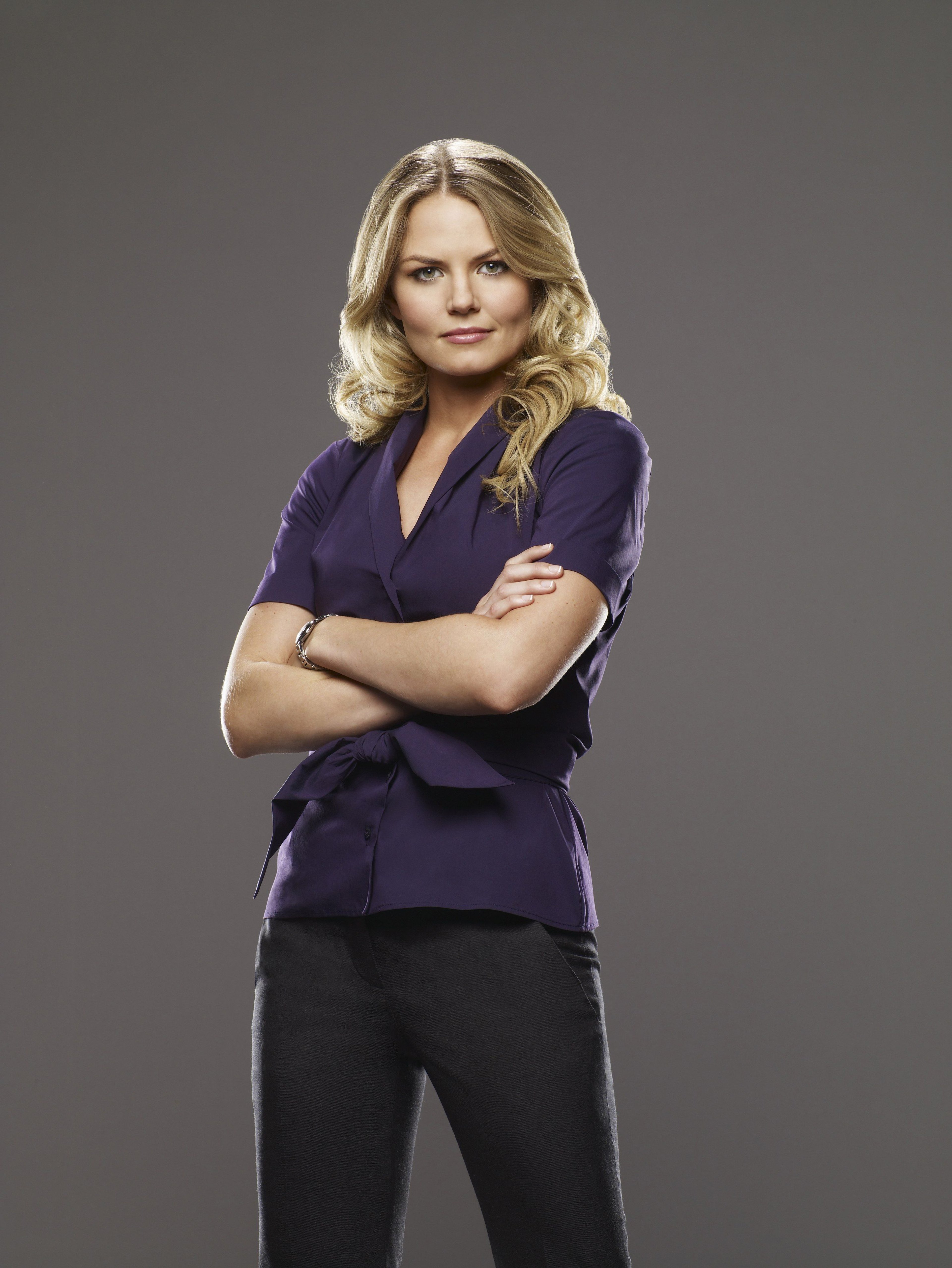 A woman with blonde hair wearing a purple blouse