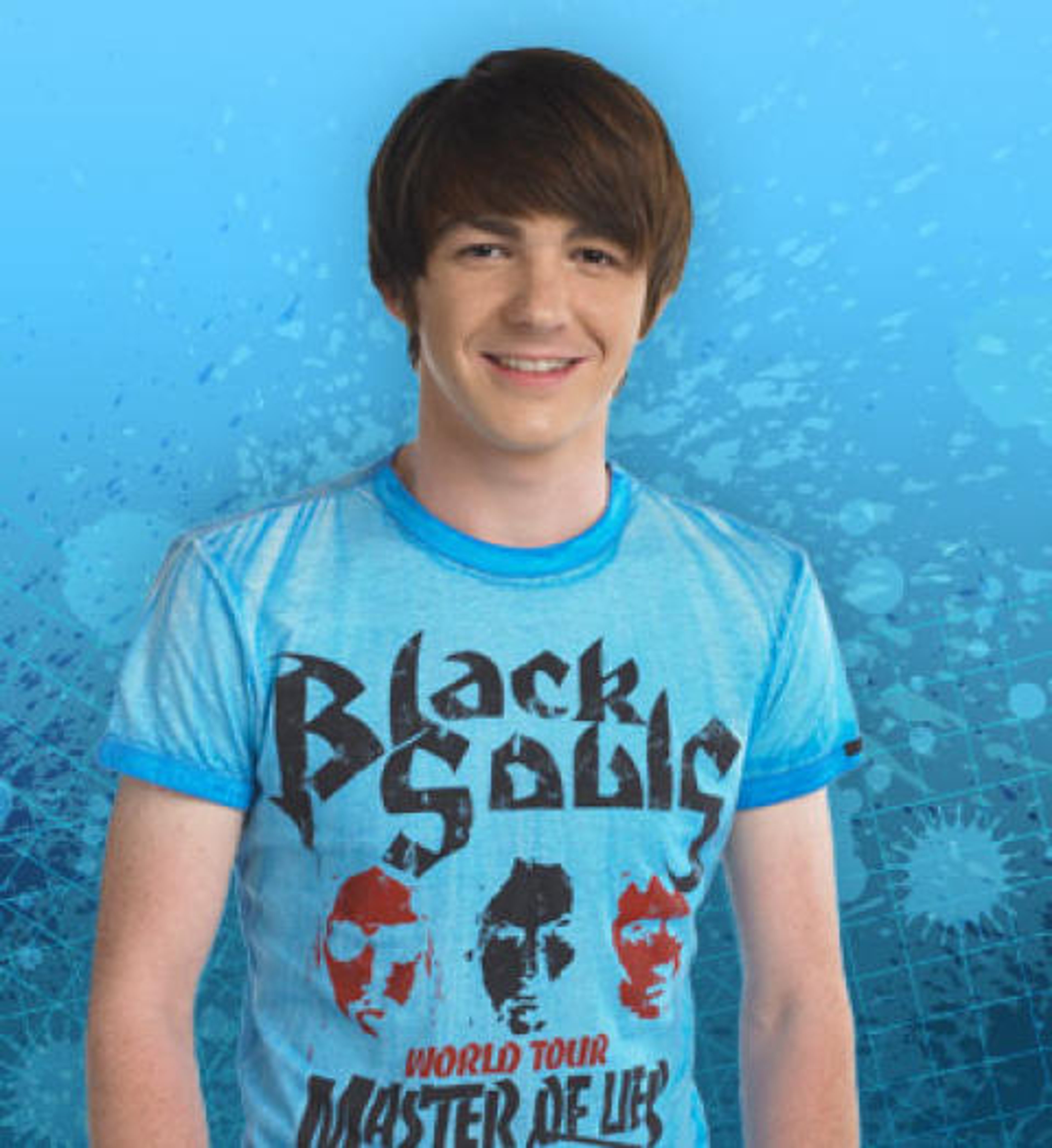 A young man with short brown hair wearing a Black Sabbath t-shirt and smiling