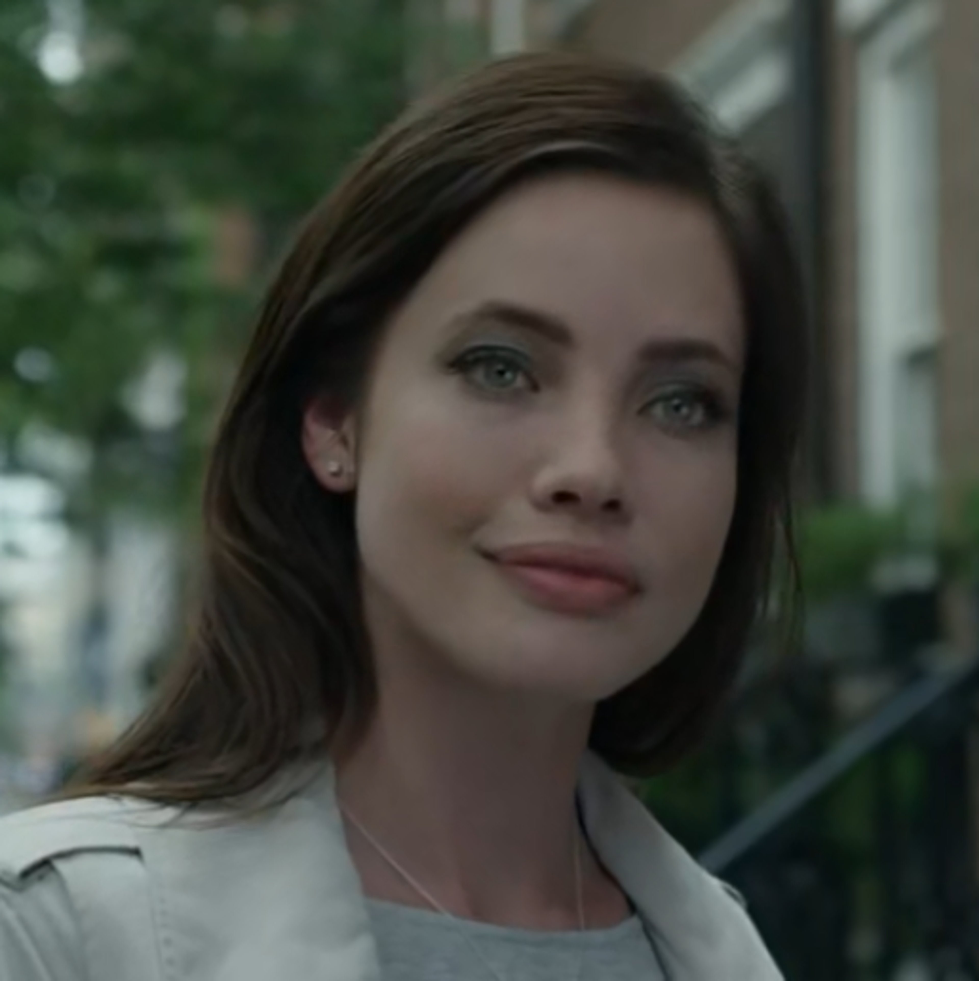 A woman with dark hair and a serious expression