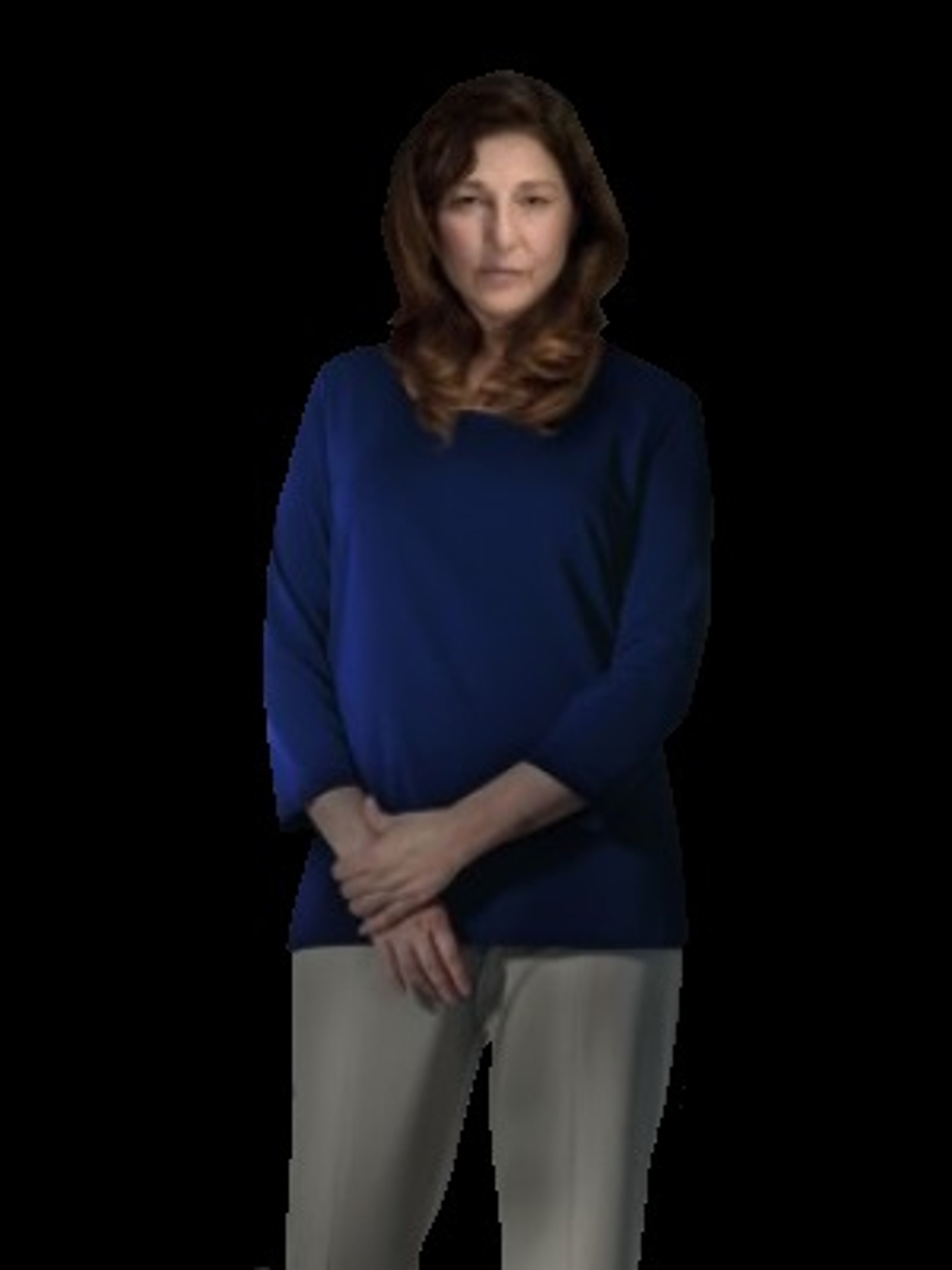 A woman with long brown hair wearing a blue sweater, standing with her arms crossed and a serious expression.