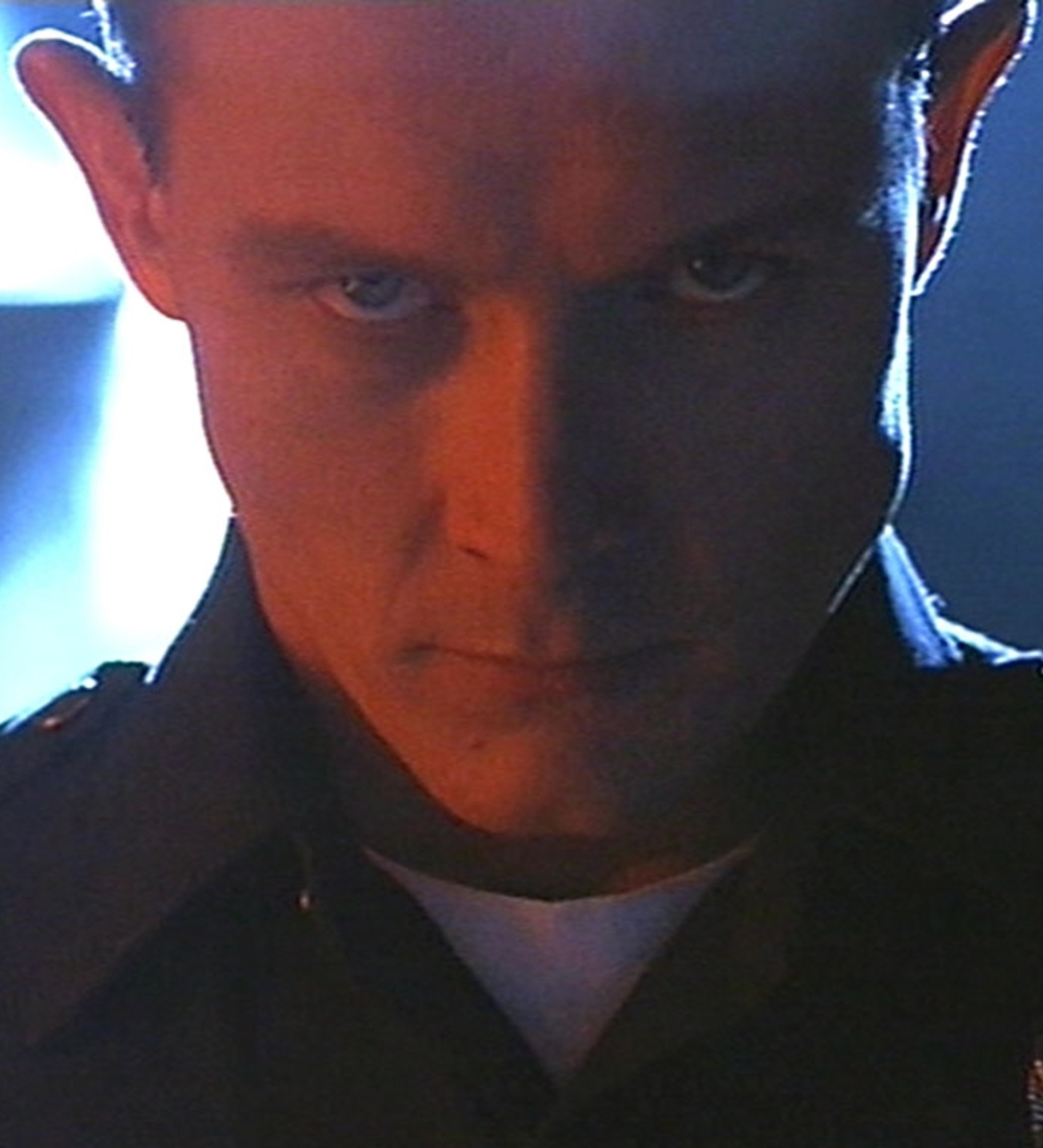 A close-up of a man's face with a metallic, liquid-like appearance, suggesting he is the T-1000 Terminator character.